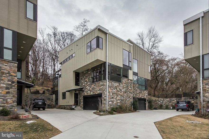 Custom Contemporary "green"  home! Open floor plan w/windows everywhere. Kitchen & bath upgrades. Beamed/wood ceilings on main level. Gutierrez staircase. Custom solar shades. LR w/gas FP. Sunroom overlooks oversized deck, stone patio & deep fenced yard. Backs to 700 ac park.  3-4 BR, 3.5 baths. Built to LEED Silver standards. Walk to Light Rail, Woodberry Kitchen. Clipper Mill pool.  2700 sq ft.