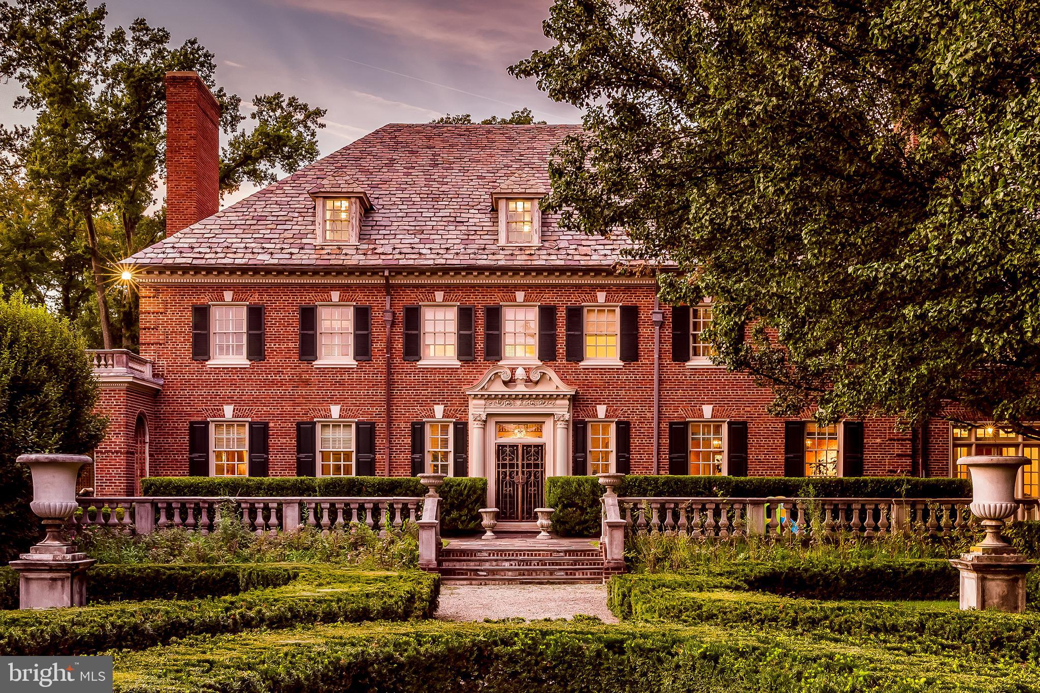 Set back behind a gated entrance and long drive on 8.4 acres, this outstanding example of early 20th-century Georgian-style architecture is a refreshing oasis in the heart of the Main Line. The brick residence has a commanding, stately presence with many of its design elements rooted in classical architecture. Its magnificent limestone front- and back-door surrounds set the tone for the attention to detail inside. Completely renovated down to the studs in 1991, its old-world features were seamlessly repaired and refreshed. Upon entering, the bright, front-to-back reception foyer, trimmed in elaborate, rich moldings and millwork, parquet floors and a dramatic, wide stairwell, is the perfect place to welcome guests. To the right is a formal living room with fireplace, parquet flooring, multiple seating areas and plenty of tall windows that bring in natural light. To the left, the formal dining room with fireplace and herringbone-pattern wood flooring includes a wall of furniture-finish built-ins. Both formal rooms as well as a family room showcase fancy fireplace surrounds and substantial millwork and moldings that run literally from floor to ceiling. The kitchen is a chefs dream with mellow cherry cabinetry, a big, granite island with two sinks, a pass-through with bar seating, stainless steel appliances including a 48in gas range, and plenty of natural light. Adjacent is a charming informal dining area with access to the grounds. Directly behind the house lies a classic English garden, perfect for relaxation or entertaining. A wraparound, Palladian-arched loggia is also the perfect outdoor room for entertaining and leads to a beautifully designed, stepped-down pool area complete with pool house providing changing room, living room and kitchen. At the edge of the formal garden, a picturesque outdoor gazebo offers views of the grounds. For additional recreation, a tennis court is located on the other side of the formal gardens. This home's private quarters include the main suite, spacious and comfortable with a fireplace and sitting area, generously-sized walk-in closets and marble-clad main suite bathroom with his and hers vanities, glass stall shower, bath tub, and hammered brass sinks. There are 3 additional bedrooms on 2nd level, all generously sized and featuring views of the grounds, and 5.3 additional baths. Two bedrooms are above the attached garage and one includes a kitchenette. All are accessible from the main house. The home includes a spacious home gym with sauna. Additional finished living space includes the rathskeller basement, perfect for entertaining with game area, bar with seating and wine cellar. In addition to a 4-car attached garage there is formal, motor-court-style parking, professional hardscaping and landscaping, lush plantings and verdant lawn. This is the complete package offering privacy, steel and brick quality construction plus a long list of updates to create a modern, comfortable home. All is tucked into a fabulous Main Line location that includes a separately deeded building lot. The property is near walking trails on the Haverford College campus, countless dining and shopping options as well as medical offices and hospitals. Close to major highways, the Philadelphia International Airport, and more.