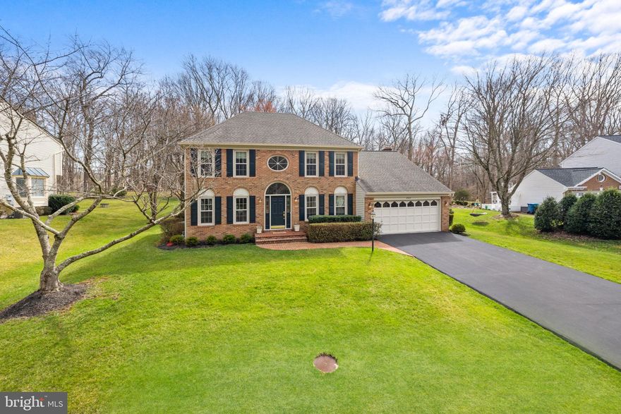 Meticulously cared for by its original owners and filled with updates, this warm, inviting, sun-soaked home is ready for you to write its next chapter.  Nestled on a beautiful .64 acre lot in the coveted Pohick Station community, this brick-front colonial offers over 3,200 square feet of spotless finished living space.  The list of updates and upgrades is beyond extensive, to include: New Roof (2017),  New Carrier Air Conditioner (2020), New Water Heater (2018), New Windows and Exterior Doors Throughout (2012/2017/2023), New Deck Re-Build (2020), Fresh Exterior Painting (2023), Fresh Interior Painting Throughout (2022), New Sump Pump and Back-up (2022), Chimney Inspection (2023), High-End Custom Curtains, Sheers, and Roman Shades (2021), and the list goes on.  The main level of the home received upgraded hardwood flooring throughout the Foyer, Kitchen, Breakfast Room, Laundry Room, and Family Room while the Kitchen offers numerous upgrades from cabinets, to Silestone countertops, to young appliances including a new Refrigerator (2017) and double ovens.  Both full bathrooms on the upper level have been renovated and feature young vanities, tile, fixtures, and commodes.  The primary bath is conveniently two rooms, one with a granite double sink vanity and another with a soaking tub, separate shower, commode, and a lovely corner set of windows.  Both areas have doors to separate them from the sleeping area.  The large walk-in closet in the primary suite offers a custom closet organizer, and all secondary bedrooms feature large closets with double doors.  The lower level of the home offers an oversized finished rec room with new windows, recessed lighting, and custom built-ins.  A secondary finished space is the perfect spot for a home gym, office, or den.  The basement continues with a massive unfinished storage and mechanical area (complete with a full bath rough-in)!  Although this list of features could go on forever, there are small details that make a house particularly special and this is one of those homes.  From the band of windows above the Kitchen sink to the double sliding doors (high-end replacement!) in the Family Room, sunlight pours from the back of this rear SE facing property...a plant lovers dream!  The private rear deck is spacious and offers the perfect spot to relax in the peacefulness of a natural setting.  When it's time to venture out, you won't need to travel far.  One of the many perks to this sought-after location is that it seamlessly blends the quiet nature of Fairfax Station with the conveniences of Burke.  Burke Centre is just six minutes away and the VRE is of similar distance, making it a breeze to get to DC without traffic.  Do not miss your opportunity to own this well loved home!