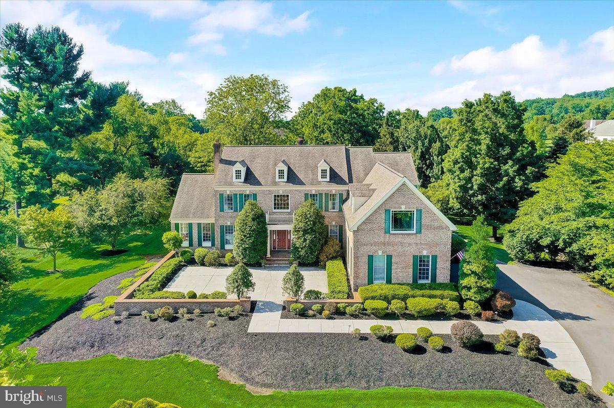 This gorgeous estate home with over 5,300 sqft of living space is located on a private lot in Upper Makefield's River Crossing neighborhood. Enjoy relaxing and entertaining on the rear stone deck that has stunning views of the lush backyard and the original barn, that was once part of the Kauffman farm. Every rear facing window has similar views which makes this location exceptional. The current owners have continually maintained and upgraded the property during their ownership. There is extensive hardscaping at the front of the house and upon entering the front door one is greeted by the bright two story foyer that opens to the living, dining and family rooms. Wood floors are found throughout most of the main level and the rooms are painted in neutral tones. The living room features a wood burning fireplace, custom molding and doors that open to the conservatory. This versatile space has a vaulted ceiling and a wall of windows that flood the room with natural light. The formal dining room was recently painted, has custom molding and updated light fixtures. The two story family room is enhanced by the second wood burning fireplace, a white bookcase that will remain and exterior doors that open to the rear deck. French doors open to an adjacent office with custom bookcase and the picture window provides views of the rear yard. The family room flows into the newly painted kitchen and breakfast area. Here is also where you will find the second stairway to the upper level. The lighting in the breakfast area has been updated and the doors also open to the rear deck. The kitchen has been renovated in recent years with new granite counters, under mount sink, backsplash and updated appliances including the gas cooktop, dishwasher, double wall ovens and built in microwave. A reverse osmosis water filtration system provides water to the Sub-Zero refrigerator and one of the faucets at the kitchen sink. Rounding out the main level is a pantry, half bath and the laundry room with brand new washer. The upper level includes the primary bedroom suite, the second bedroom with built in bookcase and desk, walk in closet and updated ensuite bathroom, and two additional bedrooms that share an updated connecting bath. The carpeting on the stairs, in the second floor hallway and primary bedroom is all new. The spacious primary bedroom suite was recently painted and includes a separate sitting area that could be used as an office or nursery. This room has an exquisite view of the rear yard. Other features of the primary bedroom suite include four custom walk in closets, a vanity area and the primary bathroom with double sink vanity, tub, shower with new glass surround and new light fixtures. Located on the lower level is the walk out basement with ample room for a future homeowner to finish. Other notable features of the property include: updated Anderson doors in the family and breakfast rooms, updated Anderson windows in the primary bedroom and bathroom, house wired for surround sound, whole house generator, insulated garage doors in the oversized 3 car garage, newly painted garage floor, underground sprinkler system in the front yard, water treatment system, security system, driveway and rear deck replaced during ownership, all upstairs closets and main level hall closet were professionally customized, 3 zones heat and A/C and the exterior A/C unit for the conservatory is new. The River Crossing neighborhood is conveniently located just south of New Hope, near several parks and in the highly sought after Council Rock School District. The location also provides easy access to all major routes into NYC, Philadelphia, and the Princeton Route 1 corridor. Come visit this exceptional property today!