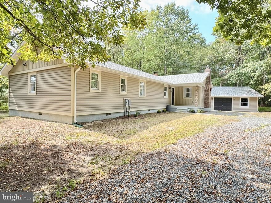 Exquisite and meticulously renovated home and separated garage on 3 acres! Nestled in a private, rural setting, but only a short drive to Delaware beaches, Long Neck, Millsboro, and Georgetown. Gorgeous sunlight and bright open floor plan with superb flooring throughout and large bay windows. This home has been completely remodeled and transformed into the perfect tucked away oasis! Brand new Elevated Sand Mound septic installed in 2024. Plenty of room for more outbuildings and an accessory dwelling unit. Previous shared driveway has been renovated into separate private drives. Call today for your private tour - This one won't last!