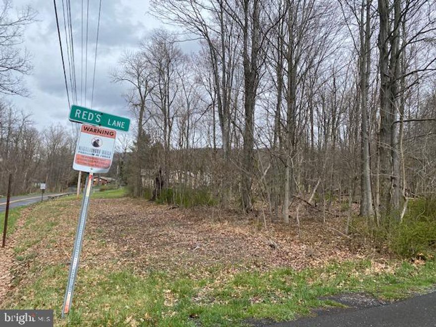 15 +/- wooded acres with a small pond. Public water hookup available. This property has not be perked.