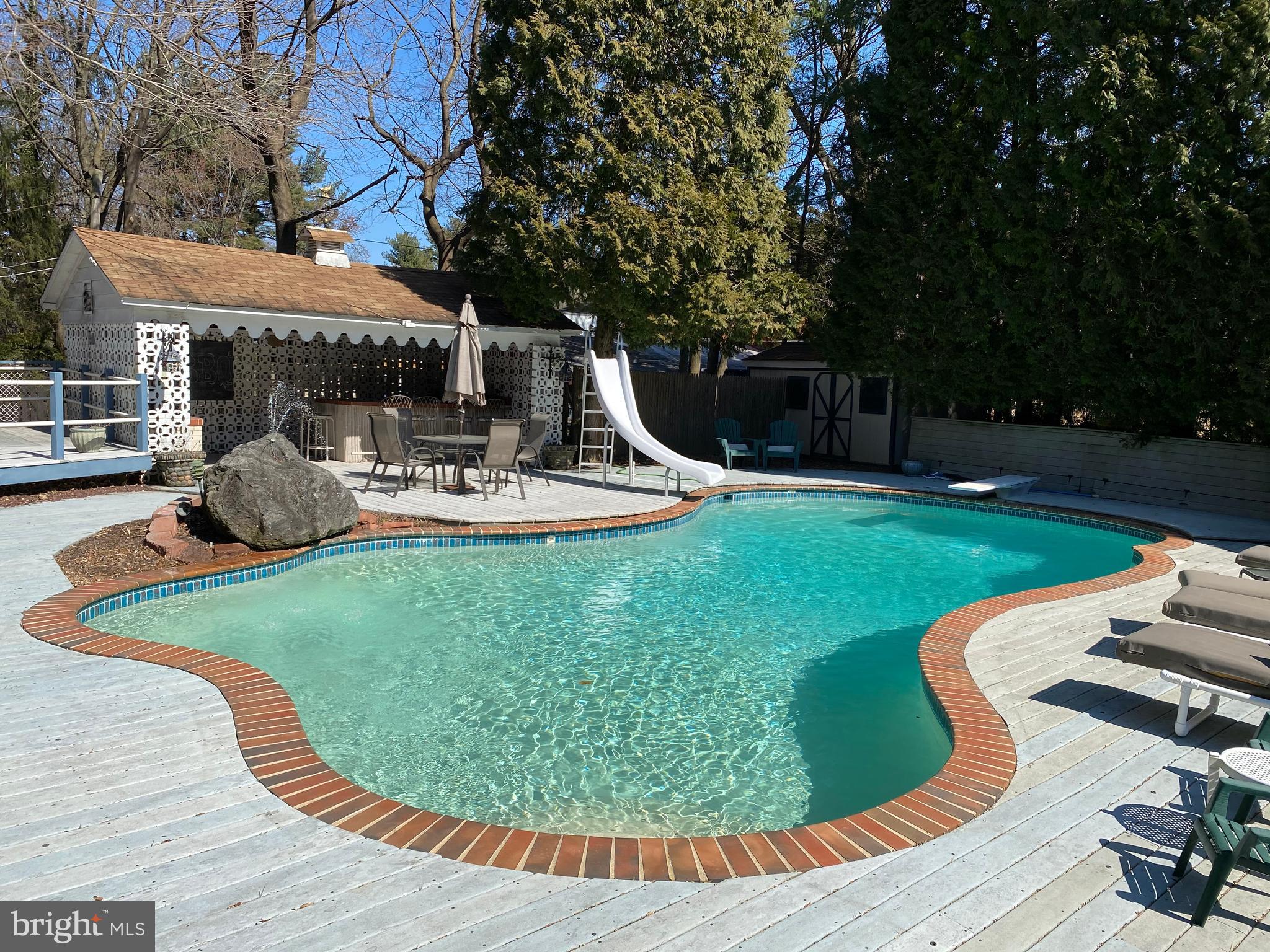 Buyer's financing fell through. Their loss is your gain! Expect to be impressed! Well situated Mid Century Modern Split level on large lot built for entertaining! Large foyer entrance will welcome you to this well updated home. Entrance level Family Room with stone fireplace, stranded bamboo floors and rear exit will make the perfect place for relaxing. Enjoy your home office/library with built in desk and storage. Fold it up at night and turn down the Murphy bed for those overnight guests! Convenient updated powder room and ground floor laundry room with new LG washer/dryer and lots of cabinet storage a plus. Four steps up to the Expansive First Floor living room with vaulted ceilings, recessed lighting, large picture window and hardwood floors. Celebrate those holiday dinners in style in this beautiful Dining Room with crown molding. You will love relaxing in the Sun Room with windows galore, recessed lighting, cathedral ceilings and outside exit that lead to patio/pool area. Newly upgraded travertine floors and carefully chosen finishes will make this your favorite room! Well planned Gourmet Kitchen with detail for the Cook to execute the perfect meals! Handsome glazed wood cabinets with some glass displays, Granite Counter Tops, Kitchenaid Wall Oven, Built in Microwave, Warming Drawer, Motion Activated Faucet, Pot Filler Faucet, Double Sink, Gaggenau Cooktop System with Steamer, Trash Compactor, Stainless Steel Dishwasher, Sub Zero refrigerators, separate island/breakfast bar with storage, recessed lighting and hardwood floors. Retreat upstairs to the unbelievable Master Suite! Spacious master bedroom with a balcony that overlooks expansive grounds and Pool. Enjoy the updated Master Bath featuring large glass enclosed shower with beautiful non slip river rock floor, faucet with body spray feature, large vanity & marble top, separate luxurious soaking tub and beautiful stone walls. Relax in the sitting room, with closets galore, decorative fireplace, sauna and skylights. This room can easily be an additional bedroom if needed. There are three additional bedrooms with great closet space and hall bathroom with shower/tub. Attic storage with pull down steps for easy access. Hardwood floors throughout this level have been refinished, master bedroom and sitting room feature new stranded bamboo floors. Don't miss the finished basement with full bathroom and outside exit! Great playroom, workout area or extra bedroom. Step outside to your personal backyard Oasis! Heated swimming pool for hours of fun on your slide and diving board! Entertain at your Wet Bar complete with built in BBQ and outdoor kitchen. Flagstone Patio, Custom Fire Pit, Trex like decking , Cabanas with two Showers and Bathroom. You will look forward to endless Summers ! See agent for additional list of improvements.   Located within walking distance to Elkins Park Train Station and the surrounding restaurants and shops. Quick commute to Center City, Airport, 309 and Turnpike.