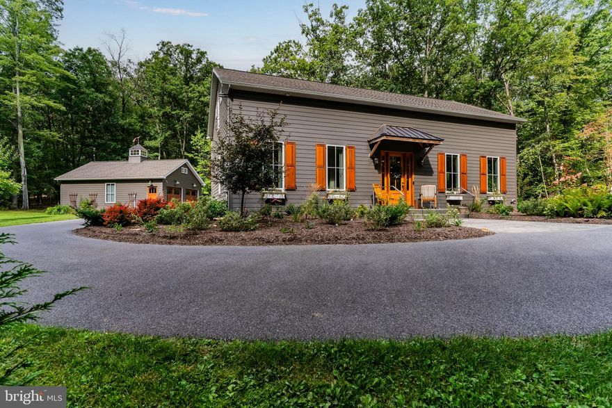 VERY unique "diamond in the rough" -designed by a discerning woman who knew what she wanted in her customized dream home, daily overseeing the construction with attention to every detail. Meticulously maintained since completed in 2019. Located at the top edge of camp/conference, it is 14 miles from Gettysburg and 6 miles to I-81 Scotland exit 20. It offers a safe and serene peacefulness that is hard to find, yet not too far away.  Study the photos for this open floor plan mini "resort" for just yourself or a gang of young-at -heart, close friends or family to join you on the week-ends! The placement of the house on 1.6 acres allows for natural light to flood the inside while viewing trees from every oversized, casement windows(w/ Levelor blinds) .10' ceilings painted pale blue (many recessed lights) resembles the sky somewhat, creating a beautiful "I  just want to stay here forever" feeling!  All custom  cabinetry in kitchen, three bathrooms and upper berths made by local cabinet maker Daniel Benedict. Reclaimed wood barn door slides over the pantry/broom closet.  Two large windowed entry doors flank the front and the back of the house, allowing  more light with  the honey colored hickory flooring through out  main floor.
The main primary bedroom ensuite has a pickled pine wood ceiling, two barn doored closets on either side leads into large, tiled shower (NO glass doors to clean!), stack washer/dryer .
Follow me up the gorgeous walnut stairs to be very surprised- an AMAZING BIG "Bunk Room" extraordinaire! 6 beds each having a closet , drawers, light & niche to charge your cell. Two skylights with recessed lights on vaulted pale blue wood ceiling add to the ambiance of this cozy carpeted luxurious hide out! One of the full baths has a stack washer/dryer for guests.
The back deck is adorned by beautiful copper overhang. Gas firepit is not too far, nor is the hammock. 6" crawl space accessed by Bilco doors houses the electric box, tankless water heater , reverse osmosis water treatment system and much more storage.  Circular driveway can accommodate many guests. Don't miss the copper peacock perched atop the glass cupola on the oversized two car garage. Well insulated, finished dry walls  could house a ping pong table or lots of outdoor equipment. Pull down stairs to storage items on fully floored "attic".
Every detail-including copper caps on cedar shutters- has been included;   Enjoy AT trails, Caledonia State Park, 2 Penn National golf courses, Long Pine Dam reservoir, Totem Pole Playhouse, Gettysburg,  Michaux XC skiing trails in close proximity- no city traffic to fight.
Seller sadly relocating only due to family circumstances , making it difficult to leave her forever home in a sweet sequestered spot.
