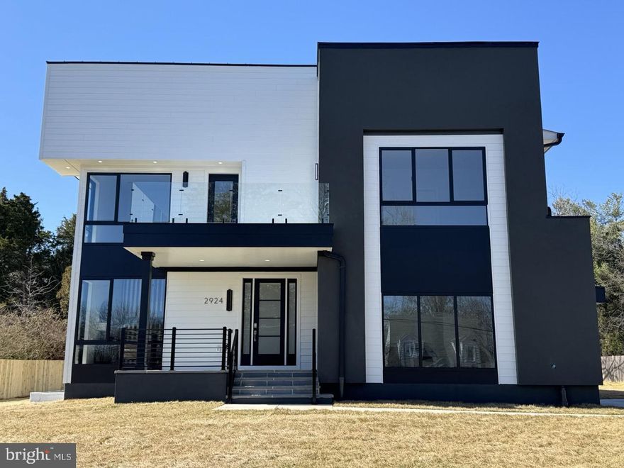 Another Masterpiece by KB Custom Homes – A seamless fusion of contemporary elegance and modern living. Boasting over 5600 square feet of thoughtfully designed space, this home embodies an elevated lifestyle minutes from the Mosaic District.
Hardwood flooring spans all three levels, complemented by abundant natural light with floor to ceiling windows. The open-concept floor plan is perfect for both everyday living and grand entertaining. Featuring five bedrooms, four full baths, and a half bath, every detail is crafted to enhance your living experience.
Design highlights include engineered hardwood flooring, a finished basement, abundant natural light, two distinct European custom kitchens on the main level:  The Chef’s kitchen, designed for culinary enthusiasts, features a Cambria Calacata Gold countertop, a fluted backsplash, and stainless steel appliances. Adjacent is a true showstopper—The main kitchen  open-concept contemporary  kitchen that seamlessly connects to the living area, boasting a large Dekton island adorned with light channels and a Dekton countertop, Stainless steel premium appliances and a Miele cooktop, Cambria Calacata Gold continuous backsplash and a paneled hood.

Elegant designer light fixtures, integrated light channels in the kitchen, primary bedroom and bath and living areas, wood paneling across all three floors to enhance the home’s modern aesthetic. Luxurious finishes continue throughout, with CB2 bathroom accessories, a striking bump-out fireplace, Porcelanosa tiles, and tiles imported from Spain, Italy and Portugal,  Kohler fixtures.  custom floating vanities for a sleek, sophisticated touch.

The finished basement offers exceptional versatility with a sleek  custom wet bar and an oversized Silestone island adorned with light channels and wood panels, Backsplash tiles imported from Portugal,  an accent wall with light channels,  and includes a versatile room adapted to your needs—ideal for a home theater or personal gym—a spacious recreation area,  and an additional bedroom with a full bath.

Prime Location: A commuter’s dream, 1 traffic light from the Mosaic District  Minutes to the Dunn Loring Metro station, 10 minutes to Tyson's and West Falls church metro station, 15 minutes to Amazon’s new HQ2 in Arlington, and 20 minutes to DC. With easy access to major highways (I-495, I-66, Route 50, and the HOV Lane) and convenient proximity to two major airports (IAD & DCA), this home is strategically positioned for effortless travel.  More than a home, this is a lifestyle.