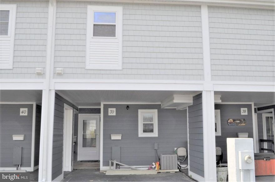 Welcome to Old Port Cove West Bayside waterfront beach retreat.  Location is everything when it is close to all amenities, shopping, beach, dining, and amusement park, etc. This is a turn key condo that comes equipped with all appliances and furnishings.  All you will need to bring is your personal items.  Custom kitchen has granite countertops and laminate flooring.  Living room with vaulted ceiling and a fireplace as well as laminate flooring.  There is a full bath on the first floor.  Upper level has a bedroom for guests. There is a private master suite with full bath, laundry facilities, and plenty of closet space. While sitting in your living room you can look out onto your new wolf pvc decking with vinyl railing and a gate for your privacy. Deck project completed March 2019. Take a few steps down to the dock and there is your own boat lift which gives you instant access to the bay with a wide main deep channel.  All you need is to bring your boat. There also is a private salt water pool for those hot summer days and nights to relax by.