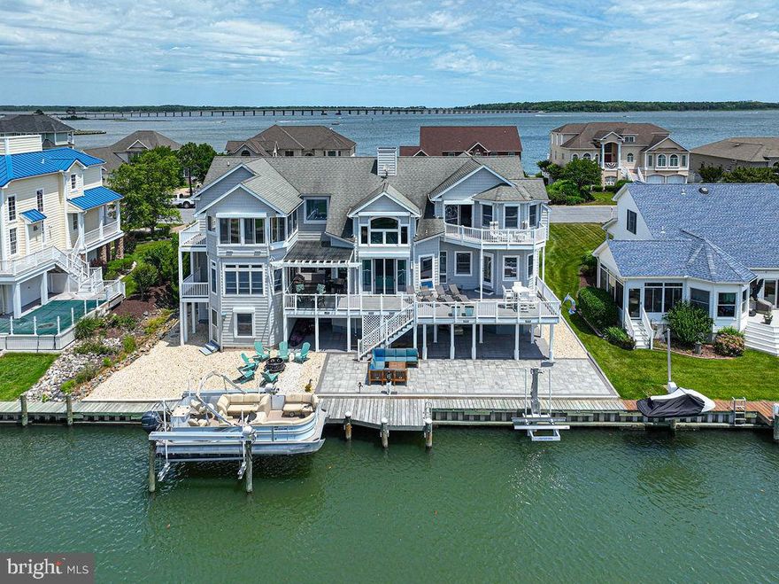 Savor the Expansive Views in every direction from this Mega-Spacious 3 level Waterfront Home with Elevator, 2 Garages, Generator, and Concrete Drive.  There is definitely a room here for EVERY occasion!  Imagine having an Island Kitchen with Granite and Stainless Steel, Breakfast Room, Formal Dining Room, Formal living room, Family Room, Office, Exercise Room, Studio, Entertainment Room, Sunroom, Storage Room and Workshop!! Two Master Bedroom suites, one includes a private deck, walk-in closets, gas fireplace with marble hearth, full bath with separate powder room, whirlpool tub, marble floor and wall tiles.  Second Master suite features a walk-in whirlpool tub/shower combo.  Extras include 2 separate Washer/Dryers for convenience, 2 water heaters, 3 zone heat/air,  5 decks, wall safe, 2 kitchenettes, large workshop, central vacuum, security system, generator, hardwood floors and surround sound.  Sellers are providing a 1 year home warranty.   90' vinyl bulkhead, and a 6'x33' Dock, front and rear paver patios, 2 boat lifts  were all new in 2020.  Prepare to be Amazed!