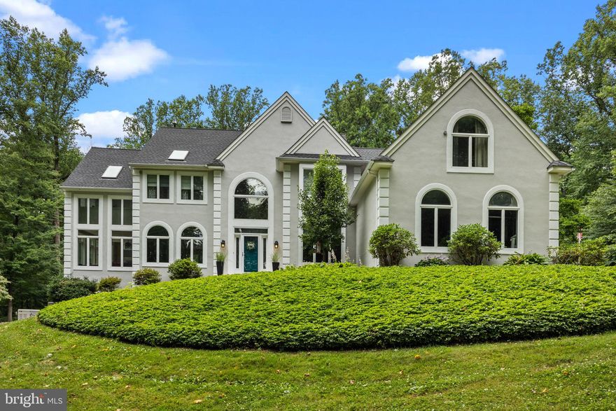 On a quiet cul-de-sac in desirable Buckingham Township, you'll find the best of Bucks County living.  Soaked in natural light and surrounded by over three acres of wooded privacy and backing up to township land, this immaculately maintained custom home offers style, sophistication, and elegance.  Enter the property by driving down the 400 foot driveway where the house sits at the peak of the property surrounded by majestic Tulip Poplar trees. Banks of windows in every room bring the rich green of the outdoors inside where the views marry with modern décor from the craftsman style balusters on the foyer stairs to the hardwood floors that run through most of the main level.  To the right of the foyer, a home office space features built-in bookcases and views of the front yard, while the dining room to the left of the foyer flows into an entertaining space with seating and a bar serving area.  From this side of the house, access a light-drenched sunroom with vaulted ceilings, walls of windows, and access to the low-maintenance back deck.  Through the kitchen, fresh white custom cabinets with deep moldings and trim make the space feel open and clean, while the granite counters carry over to the home command center and into the built-in wet bar in the adjoining family room.  A pantry closet, stainless steel appliances and oversized island make this the ideal space for the home chef.  The sun-filled breakfast area overlooks the family room and accesses the rear deck and yard.  In the family room, soaring ceilings are balanced by a stone fireplace and wall of windows and doors to the yard.  The rear staircase leads to a second level with three bedrooms plus a recently renovated skylit owner's suite, complete with three-sided fireplace between the sleeping area and the loft-style sitting area.  In the owner's bath, no expense was spared and it shows:  modern cabinetry, radiant heat flooring, a freestanding soaking tub and gorgeous two-person glass shower with tile detailing and rainfall showerhead all exude grace and style. The in-law suite bedroom could be used as two bedrooms or a bedroom with a sitting room and en suite full bath, expanding possibilities for flexibility and accommodation.  In the finished basement, newer flooring and recessed lighting make this space welcoming and a natural extension of the home.  Room for entertaining and relaxing abounds and includes a bar, seating space, complete home fitness area, bathroom, and walk-out access to the yard.  Outside, both work and play are made easy with a gorgeous saltwater pool, oversized rear deck, 400sf+/- shed with newer lighting and electrical and water hook up, playground area, fire pit area and gaga ball pit.  A three car garage and wide driveway ensure room for parking and additional storage and the full home Generac natural gas generator is powerful enough to run the entire house in the event of a power outage.  The 5 zone hot water baseboard heat and dual zone cooling also work harmoniously together to ensure comfort year round.  For man's best friend, there is an invisible fence surrounding the main yard of the property that comes with 2 integrated collars.  This home's many upgrades over the past 5+ years include renovated bathrooms, basement, updated kitchen, custom closets, new lighting, HVAC, driveway, patios and extensive hardscaping.  Truly move-in-ready and an absolute diamond of a home is in the desirable Central Bucks School District.