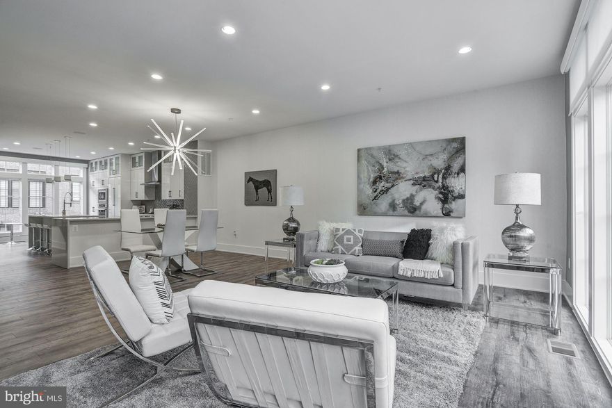 $175,000 price reduction! Previously listed at $1,799,000, and newly listed in 2020, this upgraded Avalon model has been reduced below market value and owner investment. This exquisite 2-year-young, 4-level elevator townhome is the only home available in the sold-out upscale community at the Brownstones at Chevy Chase Lake. The large (3362 finished square foot) luxury home offers a premium location within a prestigious and beautiful new neighborhood in walking distance of shops, restaurants and the Capital Crescent Trail. The spacious, open and light-filled home offers top quality construction and superb owner upgrades, high ceilings, floor-to-ceiling windows, hardwood floors, smart home features, and a large rooftop deck affording magnificent treetop and sunset views!  The open gourmet Kitchen with large island, waterfall quartz countertops,  sleek full-height cabinetry and Thermador appliances - opens to large Family Room with gas fireplace and two generous Dining Areas - on a full level of perfect space for friendly gatherings and quiet relaxation. The luxurious Owner's suite includes a gorgeous Owner's Bath with heated floor and large walk-in accessorized closets. Two additional Bedrooms on this level share another luxury Bath with heated floor. The upper level offers a large Recreation Room fully equipped as a Home Theater, with wet bar, Bedroom, full Bath, and opens to the spectacular Roof-top Deck - with plenty of space to grill and dine al fresco. The main level offers street-level entry and an Office or Bedroom with Full Bath. The oversized, two-car garage is accessed from the rear of the home, and has 2 hydraulic storage units and is electric charger-ready. Many extras convey including televisions, gorgeous window treatments, sound systems, deck furniture, grill and outdoor fireplace. This new offering of this wonderful townhome is the only opportunity to purchase in the sold-out Brownstones community and is priced to sell below the owner's investment. Consider your savings with window treatments, smart home features, televisions, designer lighting and other upgrades, over buying new construction!