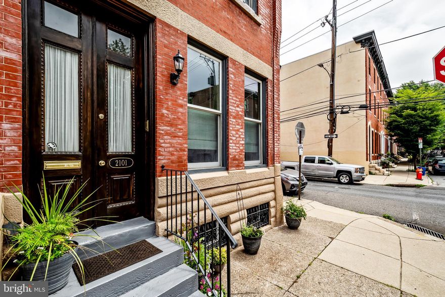 Gracing a peaceful trine lined street in the historic Spring Garden District, this refined five bedroom, two and a half bathroom corner sun filled townhouse blends classic character with contemporary elegance.
Step inside the welcoming foyer to a sunlit living room adorned with high ceilings, tall windows, intricate crown molding, a decorative fireplace and a graceful staircase featuring its original banister.
The formal dining room with chair rail, hardwood floors, ornate crown molding, built in bookcases is punctuated by a gas fireplace with an elegant mantel leads into a sun drenched kitchen built for gatherings featuring a large central island with granite countertops, GE stainless steel appliances, ample cabinetry, Travertine tile floors and backsplash, ideal for casual dining.
Just beyond, the private brick patio is perfect for serene mornings, gardening and entertaining.
The second floor rear offers remarkable flexibility with an enormous yet cozy family, office or a bedroom with a dazzling gas fireplace, hardwood floors, crown molding and a bay window. This floor also features two additional bedrooms with generous closets, a shared hall bathroom with tiled floors, dual sink vanity and a tub/shower combination and a washer/dryer closet.
The primary Suite occupies the third level offering original hardwood floors, crown molding, a bay window, high ceilings, walk-in-closet, dual sink vanity with a walk-in tiled shower.
The brightly lit front bedroom offers more versatility. It’s currently being used as a home office.
The full basement with natural sunlight awaits your vision.
Additional features include dual HVAC, security system and a Culligan water softening system. All just steps away from Fairmount Ave shops, cafes and restaurants, Whole Foods, Target, scenic Kelly Drive and world class museums.
