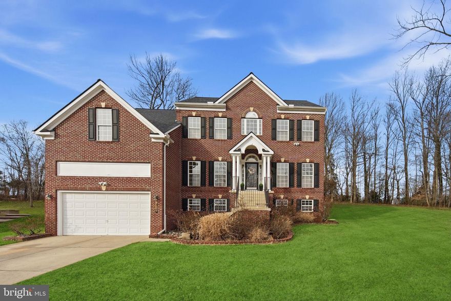 Tucked away on a peaceful cul-de-sac in Glenshire Estates, this stunning brick front colonial style home offers the perfect blend of elegance and everyday comfort. With five generous bedrooms and four full bathrooms, this versatile floor plan provides space for family to come together for life's best moments.
Enter and admire the graceful interior columns that frame your formal living and dining areas, setting the stage for memorable gatherings and quiet evenings alike. 
The heart of this home centers around the great room which beckons with a cozy fireplace, and a thoughtfully designed well appointed kitchen with your choice of gas or electric cooktop which opens to a large deck ideal for morning coffee or summer barbecues. 
Upstairs, complemented by a luxurious bathroom, the spacious primary bedroom awaits with an optional sitting area, offering a private sanctuary to unwind. 
The finished basement expands your living possibilities with a fitness space that offers flexible use options. Movie enthusiasts will fall in love with the dedicated movie room featuring a wet bar and built-in surround sound speakers, perfect for those cinematic experiences without leaving home. Outside, the generous outdoor space provides room for gardens, play areas, or simply enjoying the fresh air.
Recent updates include a new HVAC system, giving you peace of mind for years to come. Conveniently located close to shopping and transportation, this location truly has it all.
