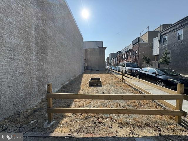 An exceptional opportunity presents itself at 1313 S 23rd St in South Philadelphia’s dynamic Point Breeze neighborhood: a rare 18‑foot‑wide corner vacant lot directly facing Wharton Square Park. Situated along Wharton Street on the park side of the block, this highly visible parcel sits across from a well‑maintained community greenspace featuring tennis courts, playground areas, wildflower gardens, and planned rain‑garden enhancements . While uninterrupted skyline views cannot be guaranteed, the location offers strong potential for building a home with outlooks to the park—and possibly Center City—depending on design and height. The lot measures approximately 18 × 63 ft (about 1,132 sq ft) and is zoned RSA‑5, aligning with Point Breeze’s evolving trend of infill townhouse development . With a growing wave of modern renovations and new construction nearby, this blank canvas offers endless possibilities—from a custom single‑family home to a sleek spec build. Whether you envision direct park views, a thoughtful facade on a prime corner, or a design that capitalizes on neighborhood momentum, this parcel combines city‑scale visibility with community charm. All utilities are available at the street, and the proximity to neighborhood amenities—including nearby eateries, transportation, and retail—makes this an ideal location for buyers or developers looking to make their mark in one of Philadelphia’s most promising corridors.