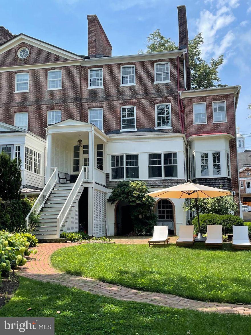One of the most historic and distinguished homes in Downtown Annapolis. This beautifully maintained residence combines timeless charm with modern livability. Gracious proportions, soaring ceilings, and original wide-plank heart pine floors set the tone, while architectural details—arched doorways, crown molding, French doors, and classic mantels—add warmth and character. The English basement includes two versatile bonus rooms, including a charming “Pub Room” with the original kitchen hearth. Enjoy peaceful surroundings and the convenience of a private driveway, large rear yard with several additional parking spots—all just steps from City Dock, marinas, and the Naval Academy.