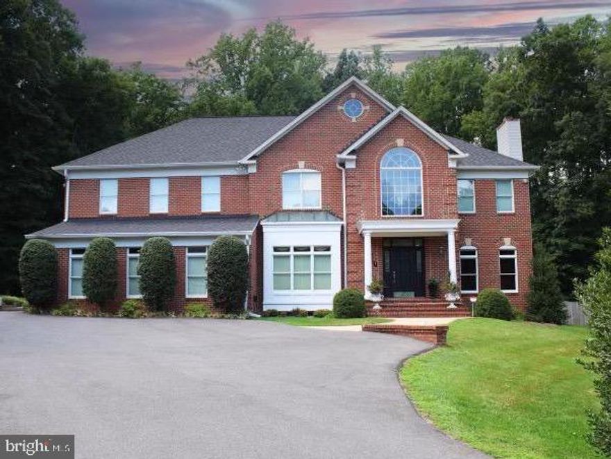 Welcome to 3500 Russell Thomas Lane, an elegant colonial home in Davidsonville, MD, situated in the sought-after Avila Community. This meticulously maintained residence offers 8,637 square feet of light-drenched living space, enhanced by 10 ft ceilings on the first floor. Nestled at the end of a cul-de-sac and surrounded by woods, this home ensures extreme privacy. The two-story entry features stunning marble flooring, leading to a formal dining room and a custom Honduras Mahogany Library complete with a gas fireplace. Gleaming hardwood floors, architectural columns, and oversized crown and base molding adorn the home. The gourmet kitchen is a chef's dream, equipped with an oversized island, two refrigerators, a cooktop, double wall oven, beverage cooler, and ice maker. Adjacent is a cozy family room with its own gas fireplace. The main level also boasts a newly renovated bath with a steam room, an additional gathering room, and a large laundry room. The master suite is a true retreat, featuring enormous his and her walk-in closets and a luxurious master bath with new showers (2023). The lower level includes an exercise/workout room and a rec room. Outdoor living is at its finest with a new 20 x 40 gunite pool (2019), firepit, grill, and patio pavers. Modern conveniences abound, including a Generac generator, recessed LED lighting, a tankless propane water heater, and Anderson double-hung vinyl clad wood windows. Located just 20 minutes from Downtown Annapolis, this home offers both privacy and convenience, making it the perfect gathering place for family and friends. Davidsonville blends rural charm with a small-town vibe, offering something for everyone.