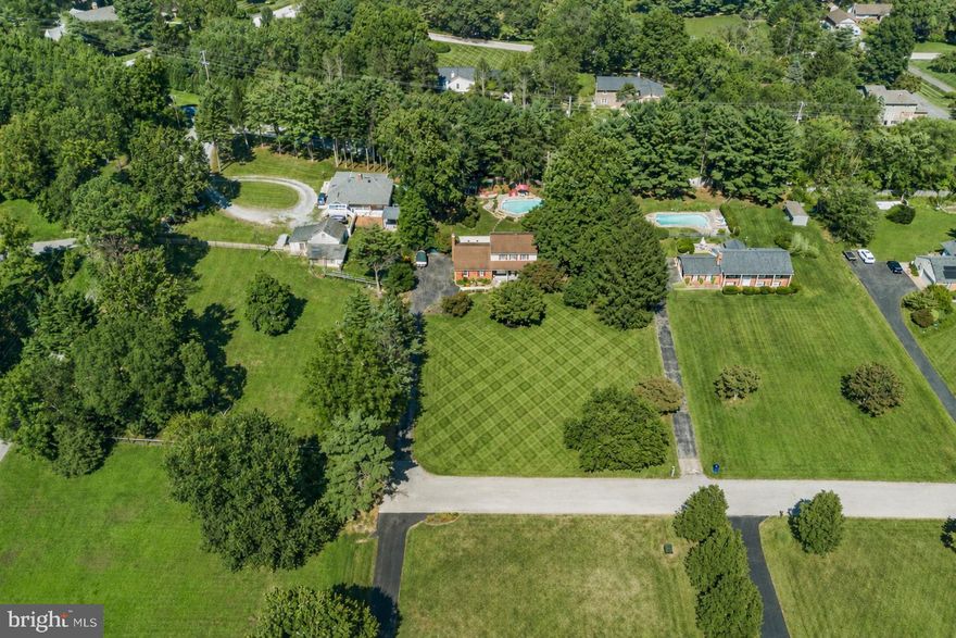 An exceptional entertainer’s retreat on a serene, one-acre lot in Highland, located in the Blue Ribbon award-winning, River Hill High School district. Tucked at the end of a quiet street with no through traffic in White Oak Estates, this home offers the perfect blend of peaceful country living and everyday convenience. Move-in ready from day one, this home is ideal for today’s busy lifestyle; simply close, unpack, and start enjoying everything it has to offer. The main level was fully remodeled in 2020, featuring a stunning kitchen with granite countertops, black stainless LG appliances, an oversized 8’ island, pantry, updated flooring, recessed lighting, and a beautifully renovated guest bathroom. The primary bath was completely renovated in 2023 with upscale finishes and incredible custom tile work. Designed for both relaxation and entertaining, the bright sunroom opens seamlessly to an expansive deck with a hot tub, overlooking a glistening, low-maintenance saltwater pool (resurfaced 2019, new salt cell 2025, professional cleaned and refilled 2026). This private backyard oasis, surrounded by a variety of mature trees, offers endless opportunities for gatherings, quiet evenings, and the creation of lasting memories. Two versatile sheds add storage and flexible space. Additional highlights include 4 bedrooms/3.5 baths -- Main-level bedroom/office option -- Updated HVAC (2022) -- Fresh paint (2026) -- Updated dishwasher, refrigerator (2020) -- Water heater (2016) -- Well equipment serviced (2025) -- Septic pumped (2023) -- LVP/Wood flooring -- Crown molding -- Fireplace w/ wood stove insert (Low heating costs!) -- Finished basement w/ full bathroom -- Built-in shelving & spacious storage area -- Covered front porch -- Large parking area -- Attached, sideload garage -- Open concept floorplan -- No HOA -- Enjoy close proximity to Triadelphia Reservoir, just 1.5 miles to Boarman’s Market, approximately 5 miles to River Hill Village Center, and about 8 miles to Maple Lawn’s shops, dining, and entertainment. A rare opportunity to purchase a turn-key, lifestyle-driven home designed for comfort, convenience, and year-round enjoyment that the owners have professionally prepared for the next owner. PS - Pool was drained, power washed, and filled with fresh water this month, and it is open and ready for summer. Bring your goggles and a towel! There are virtually staged/enhanced images in this listing.
