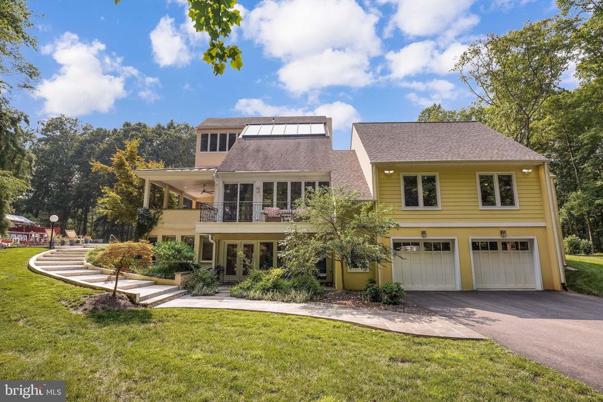 This updated unique contemporary estate sits on nine acres of trees and rolling hills.  The flexibility of this custom build allows the owners to vary how they wish to use the property.  It is equally an entertainer’s dream, able to host indoor/outdoor parties of 100 people seamlessly, and create intimate spaces for small groups or quiet time with the family. There are porches and decks on all sides of the home to join indoor and outdoor spaces. The front lawn provides parking for dozens of cars along the meandering 700 foot driveway.  The home is minutes from the quaint town of Clifton that forms the nexus for the community with its restaurants and shops. 
 The bright open layout with strategically placed windows frame views of the scenery while affording privacy to the occupants.  There are five bedrooms with en suite or adjacent baths across the house, that easily accommodate both a multi-generational and/or growing family.  The kitchen, featuring high end appliances, flows into sitting and sunny eating areas.  The four large wood burning fireplaces provide focal points and warm comfort.  The room sizes are comfortable with varying ceiling heights that create cozy and expansive enjoyment areas.  A main floor adjoining apartment with both exterior and interior entrances, built in 2017, provides ample space (bedroom, living, laundry, office and kitchen) for in-laws or a grown child starting out. The apartment is both connected and distinct. The Primary bedroom suite features a spa-like spacious bath with claw-foot tub and steam shower and a large closet with custom fittings.
The outdoors features a lovely pool with spacious decking, a raised platform for additional entertaining, a fire pit area and separate workshop.
 This home is definitely not builder grade, but built to last.  The four stories of the main house boast concrete block walls spanning its 40+ feet of height with floors supported by true 3”x10” solid wood beams.  The plumbing has been completely upgraded, along with most of the electrical and roof.  The four zones of heating / air conditioning are designed to optimize climate control.