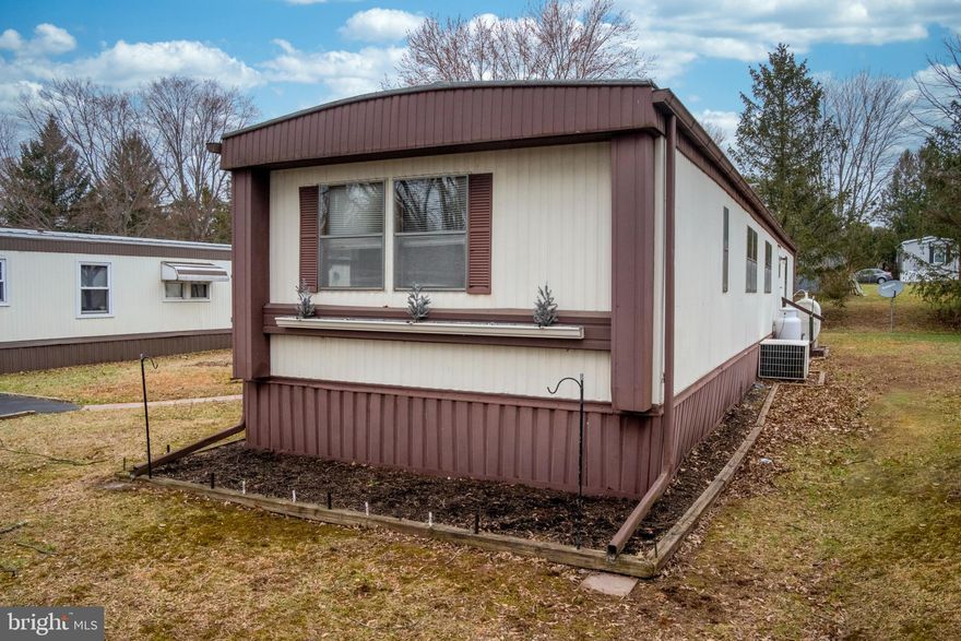 Welcome to this well-maintained 2 Bedroom, 2 Full Bath manufactured home offering comfortable and easy living at 9 Oak Drive located in sought after Owen J Roberts School District. Step inside to find a functional galley-style kitchen with ample cabinet and counter space, gas range and refrigerator which is perfect for everyday cooking. The adjacent dining room flows seamlessly into a spacious living room featuring a cozy wood burning fireplace—ideal for relaxing evenings at home. The primary bedroom includes its own full bath with soaking tub and a walk-in shower which is located in the rear of the home. Private laundry is conveniently located right outside the primary bedroom. In the front of the home there is a second bedroom and an additional full bathroom which provides flexibility for guests or a home office. Additionally there is a covered patio, spacious shed for extra storage and a paved driveway which comfortably fits two cars. A great opportunity awaits for affordable living with a warm and inviting layout!