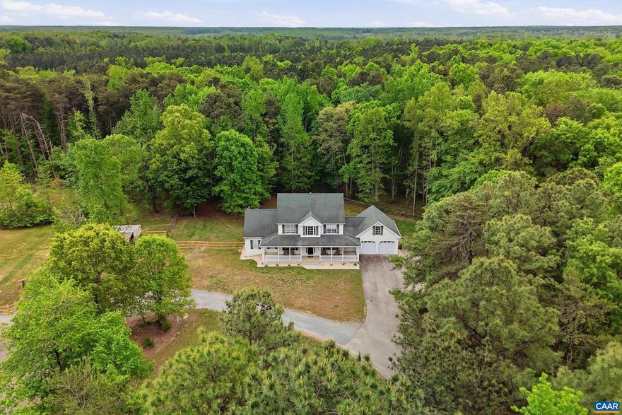 Dream farmhouse on 6+ private acres with the front porch you?ve been waiting for! This 5-bed, 4.5 bath home features wood floors, a main-level primary suite with soaking tub & walk-in closets, and a bright open kitchen with pantry. Cozy up by the gas fireplace or spread out with a family room, dining space, and home office. Upstairs offers 3 bedrooms and 2 full baths, plus a full walkout basement with a 5th bedroom, a full bath, a rec room, and a storage room. Enjoy the covered back porch with Trex decking overlooking a fenced pasture, horse run-in, and custom chicken coop. Massive 56x68 shop with on-site office?perfect for business or hobbies. Dual HVAC, outdoor wood boiler, attached 2-car garage, and total privacy. Country living done right.