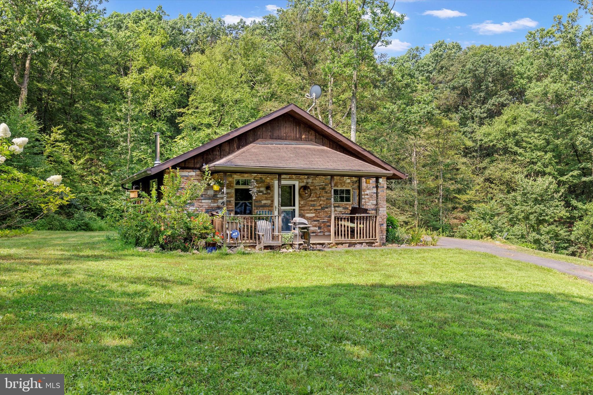 Tucked away on a peaceful 1.53-acre wooded lot, this 3-bedroom, 2-bathroom home offers privacy, serenity, and room to grow. Step inside to an inviting open floor plan with cathedral ceilings that create a spacious, airy feel perfect for everyday living or entertaining. The walk-out basement offers endless possibilities to finish and customize the space to suit your needs.
Enjoy the beauty of nature right from your doorstep. Relax to the sounds of the stream running through the property, watch for wildlife, and take in the tranquil surroundings year-round. A whole-house generator provides added peace of mind. Whether you’re looking for a full-time residence or a private retreat, this property offers the best of both worlds.
Don’t miss your chance to own this peaceful slice of paradise!