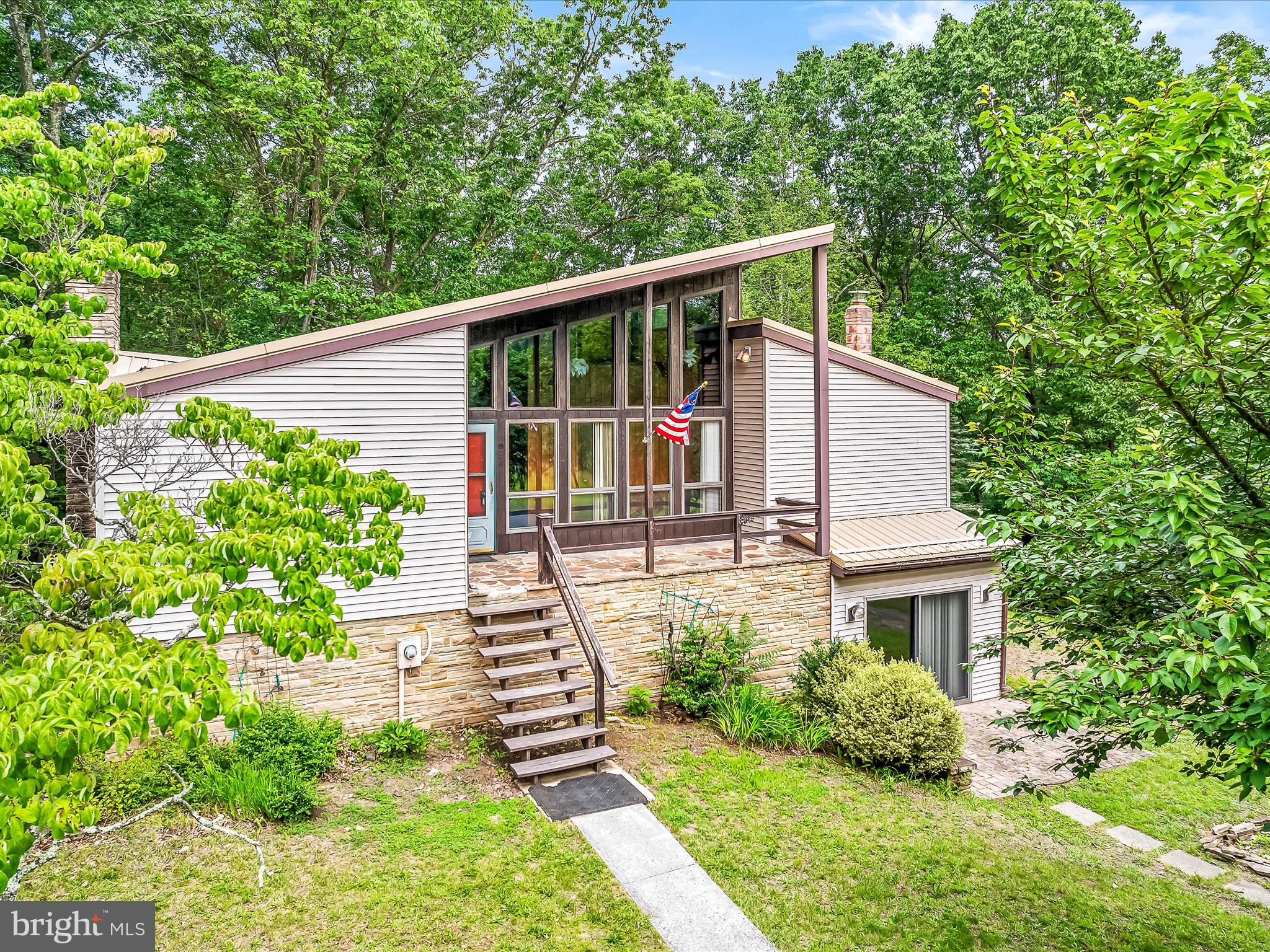 Come and admire this unique home situated on 22 secluded acres consisting of fields and woods. Home is contemporary in design and offers a ton of potential. Lots of natural light from all of the windows. Features a wood stove and a fireplace also. Wooden accent beams upstairs really set off the look. A large detached garage for parking and storage. Full finished basement for extra living space and storage. Stone accent walls surround the bottom portion of the home as well. A must see!