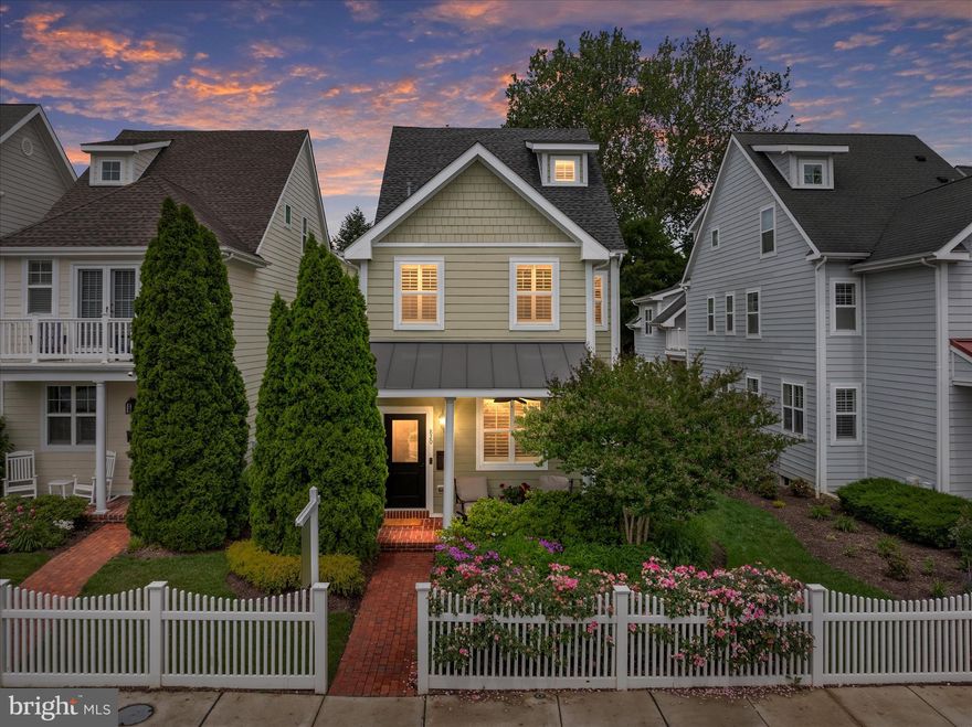 An elegant expression of space, style, and coastal living, 820 Bay Ridge Avenue offers four beautifully finished levels in the heart of Eastport’s coveted Sailor’s Quay enclave. This thoughtfully designed Modern Craftsman presents with quiet sophistication—from the white picket fence and manicured grounds to the gracious brick front porch—setting the tone for refined yet comfortable living. Inside, rich hardwood floors, 9’ ceilings, tray ceilings, finely detailed millwork, and plantation shutters throughout create a polished and cohesive backdrop for both everyday life and elevated entertaining. The gourmet kitchen is timeless and functional, appointed with honed granite countertops, premium appliances, and a substantial center island, while the adjoining living room offers warmth and ease with a fireplace and inviting gathering space. For more formal occasions, a separate dining room provides an elegant setting, centered around a beautiful chandelier and enhanced by refined detailing, with an adjoining sitting room or study—perfect for quiet moments, conversation, or an evening bourbon. Outdoor living is equally considered, with a charming flower garden-facing front porch, a private English courtyard patio, and a second-floor terrace ideal for unwinding at day’s end. The primary suite offers a serene retreat, complete with a custom walk-in closet, a spa-inspired bath, and a full-sized sitting room that creates a true sense of space and privacy. The second level is further enhanced by a spacious junior suite with a private bath, ideal for guests or extended stays, while the upper level features two additional bedrooms with vaulted ceilings and a well-appointed shared bath. The finished lower level provides a generous family room and full bath, offering flexibility for a variety of uses. Designed with long-term livability in mind, the home includes a discreetly integrated elevator shaft spanning all four levels, offering the option for future installation without impacting the home’s current aesthetic or flow. Perfectly positioned just moments from the charm and energy of downtown Annapolis and the iconic United States Naval Academy, this location delivers an exceptional lifestyle—walkable to waterfront dining, boutique shopping, art galleries, and the vibrant coastal culture that defines the area. Whether strolling across the Spa Creek drawbridge or arriving by water taxi, the connection to town is effortless. With convenient access to Rt. 50 and 97 for commuting to Baltimore, Washington, and beyond, this is a rare opportunity to own a home of true distinction in one of Annapolis’ most desirable settings.
