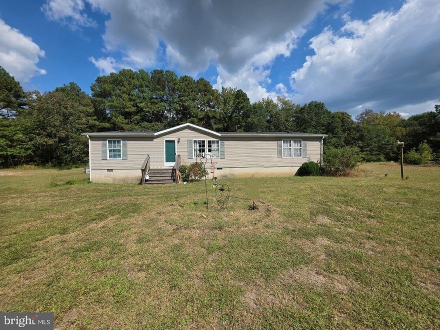 What an opportunity at an incredible price. Home is situated on over 6 acres in scenic Wicomico County. Cleared areas provide space for recreation, gardening, and gatherings, while the wooded acreage offers natural seclusion and abundant wildlife. The home features a spacious layout with generous living areas and a peaceful rural setting surrounded by nature. While the property does require some updates, it provides a rare chance to customize and create your vision on a sizable parcel of land.  When you enter the home, you will find an ample living room with 2 large windows that invites natural lighting. Towards the back you will find the large kitchen, which is fully equipped and flows seamlessly into the dining area.  Here you will also find a door that leads you to the laundry room and a door that leads you to the backyard. The home offers 4 ample bedrooms with the primary suite on one side of the home and remaining 3 bedrooms  and full bath on the left wing. The house is conveniently located next to Route 50 and the west side of the county. Embrace the serenity and create your perfect retreat in this peaceful, scenic setting!