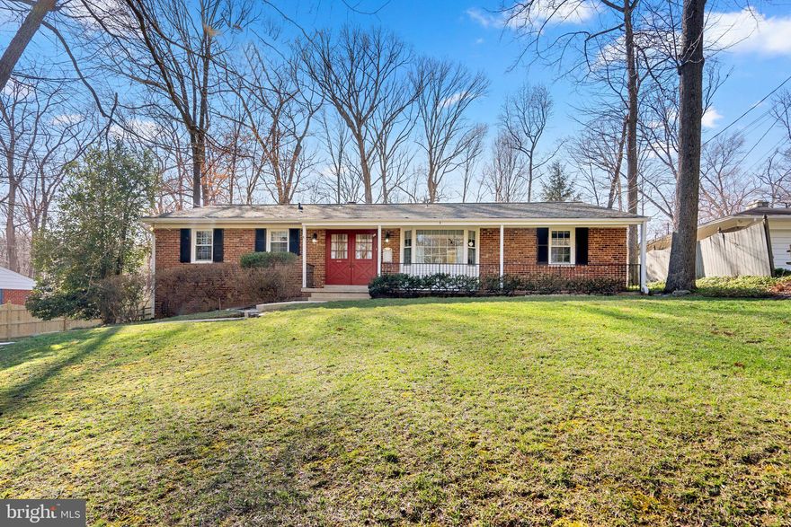 Welcome to a little slice of heaven on almost 2/3 of an acre located on a beautiful street in the Oak Springs subdivision! This special brick home with one level living has been lovingly cared for by the same family since 1965. You'll have plenty of room with 3 bedrooms, 2 full baths on the main level and additional living spaces in the finished lower level with its private side entrance, not to mention a full bath. The large backyard is perfect for enjoying the outdoors and a deck is just waiting for you to host summer barbecues! The oversized driveway with an additional parking pad will provide all of the parking you'll need and the detached 2-car brick garage is equipped with a service door, front garage door and another garage door at the back . . . so car aficionados can drive their prized vehicles straight through. And lucky for you, this home is set on a private, not-through street and has a cozy front porch! MAIN LEVEL: Upon entering this charming home via double doors, you will be met by a huge living room with a large picture window which lets plenty of sunshine in! The brick fireplace is sure to make your home feel special and inviting on those cold winter nights and is perfect for cozying up with a good book or great conversation. Off of the spacious family room is a charming dining room area which has French doors to access the most wonderful 4-season sunroom with a vaulted ceiling with a lighted ceiling fan and egress to a deck with built-in bench seating! The coziest tablespace, updated kitchen with an immense picture window offers rich wood cabinets, granite countertops, tile backsplash, a pantry, and beautiful wood floors. The primary suite has its own bathroom featuring a shower, while the full hall bath has a tub perfect for relaxing in after a long day! Two additional bedrooms complete the main level. LOWER LEVEL: You will love the lower level's perfect layout featuring a huge rec room with plenty of room for relaxing and entertaining. There is also a convenient home office/potential guest room and this level has a full bath lending itself to being a home within a home - especially with its own exterior entrance. A laundry room with a large utility sink and closet, as well as a spacious mechanical/storage area with conveying work benches complete the lower level. The back yard is amazing and be sure to enjoy the brick columns with horse heads mounted on top and an iron gate which could lead to the most perfect secret garden! This comfy, yet spacious home, is in a fantastic location just minutes to Route 29, the ICC, shopping, restaurants, and much more that this area has to offer! Public water & sewer and no HOA!