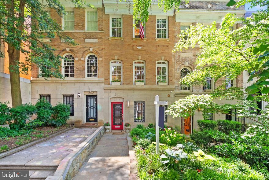 Introducing The Somerset, a stately 16’8” wide brick and limestone rowhouse designed in 1918 by renowned DC architect George Thomas Santmyers.  This embassy-style residence stands proudly on a tree-lined block in Kalorama Triangle—one of DC’s most architecturally rich and coveted neighborhoods.  Meticulously updated while preserving its original grandeur, The Somerset blends historical charm with modern comforts. Recent upgrades include a new roof (2021), both chimneys relined (2021), new HVAC system (2025), newer washer/dryer, fresh paint, and replaced rear decking.  Step through the grand front entry into a gracious reception room with original moldings and a wood-burning fireplace. Beyond the reception room, a generous family room features newly installed cashmere carpeting (2021), an en-suite marble bath, and a flexible bedroom space that could be used as a guest suite, office, or home gym.  The heart of the home unfolds upstairs, where a formal living room with a second fireplace and trio of arched windows creates a dramatic yet inviting entertaining space.  The elegant dining room, complete with a 6-foot mahogany pocket door, leads to a professional-grade kitchen with an adjacent breakfast area.  French doors open to a beautifully designed, multi-level garden and freshly updated and painted deck—an entertainer’s dream.  A rare 2-car tandem garage sits just beyond.  Upstairs, three large bedrooms await under three stunning skylights. Two full baths, including one with a steam shower, and custom closet space complete the upper level.  The Somerset is nestled on a quiet block of mature Ginko trees and surrounded by the finest examples of Georgian Revival, Colonial Revival, and Mediterranean architecture. With a 94 Walk Score, enjoy being moments from metro access, Rock Creek Park, Dupont Circle, and the city’s top dining and shopping.