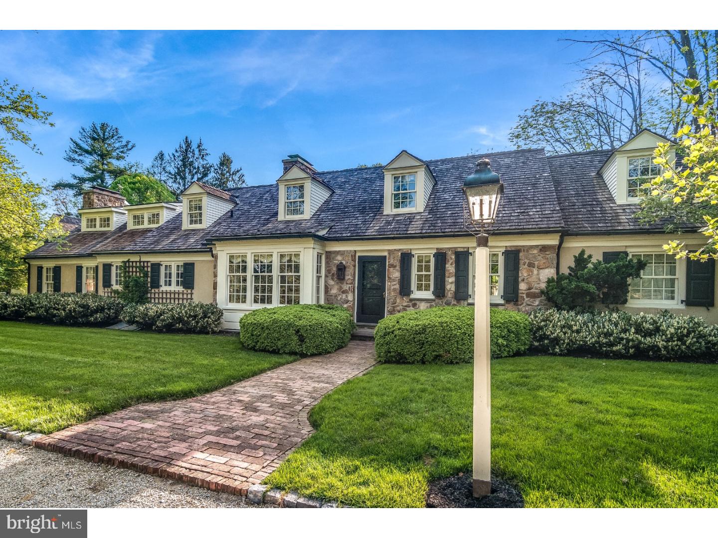 This expanded stone front Cape w/cedar roof, copper gutters and downspouts is perfect for the discriminating buyer. Attention to every detail from the custom millwork and hardwood floors with brick accent to the perfectly manicured lawn, specimen trees and gardens. The gourmet kitchen is a chef's delight with Cherry counters, stainless island with prep sink, Sub Zero refrigerator, DCS stove, even a pizza oven. The kitchen overlooks vaulted sky lit great room with raised hearth fireplace, and shiplap detail on the ceiling. The 1st floor main bedroom with walk in closet and gas fireplace has French doors that open out to one of two bluestone patios. A lovely turned staircase leads to two additional bedrooms with oversized closets and sitting room on the second floor. Access a well appointed apartment over the heated 4-car attached garage via sunlit mudroom. Relax or entertain by the beautiful pool and spa complete with cabana. Very private, fully fenced yard has lush plantings, amazing barn-like shed and a 12 zone irrigation system. There are 3 fp's, a new Weil McLain furnace (2016) a partially finished basement, central vac, cedar closet and more. A 1998 Parec renovation designed by Architect Rene Hoffman with Landscape design by Leslie Purple and Alice Farley. Perfectly situated minutes to Chestnut Hill, Erdenheim Farm, Sunnybrook and Philadelphia Cricket Golf Courses.