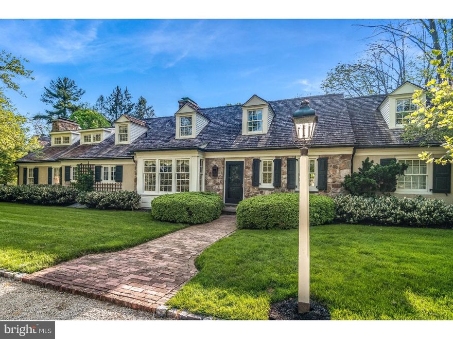 This expanded stone front Cape w/cedar roof, copper gutters and downspouts is perfect for the discriminating buyer. Attention to every detail from the custom millwork and hardwood floors with brick accent to the perfectly manicured lawn, specimen trees and gardens. The gourmet kitchen is a chef's delight with Cherry counters, stainless island with prep sink, Sub Zero refrigerator, DCS stove, even a pizza oven.  The kitchen overlooks vaulted sky lit great room with raised hearth fireplace, and shiplap detail on the ceiling. The 1st floor main bedroom with walk in closet and gas fireplace has French doors that open out to one of two bluestone patios. A lovely turned staircase leads to two additional bedrooms with oversized closets and sitting room on the second floor. Access a well appointed apartment over the heated 4-car attached garage via sunlit mudroom. Relax or entertain by the beautiful pool and spa complete with cabana. Very private, fully fenced yard has lush plantings, amazing barn-like shed and a 12 zone irrigation system. There are 3 fp's, a new Weil McLain furnace (2016) a partially finished basement, central vac, cedar closet and more. A 1998 Parec renovation designed by Architect Rene Hoffman with Landscape design by Leslie Purple and Alice Farley.  Perfectly situated minutes to Chestnut Hill, Erdenheim Farm, Sunnybrook and Philadelphia Cricket Golf Courses.