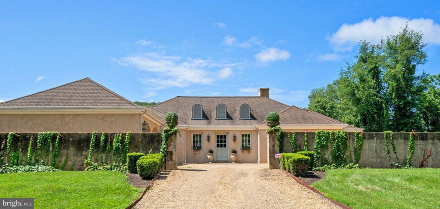 Improved price!!!! Priced below appraisal. Welcome to Morningstar Farm – a serene and sophisticated retreat nestled in the heart of Virginia’s famed horse country. This refined French Country estate, designed in a classic U-shape and arranged on a single level, is the creation of renowned architect, Rod Youngson, and  thoughtfully crafted by and for a well known interior designer. Set on 31.22 picturesque acres between Middleburg and The Plains, the property enjoys privacy along a winding gravel road, yet remains remarkably convenient—just minutes from Routes 66 and 50 and an easy drive to Dulles International Airport.   Very manageable design. Desirable, single level living. Floorplan optimal for entertaining. 
From the moment you enter the walled motor court, the home’s impeccable design is apparent. The home opens to a grand drawing room that serves as the heart of the home, seamlessly connected to the gourmet kitchen. Soaring ceilings are accented with antique hewn barn beams, while floors of imported limestone and pickled oak and a dramatic  fireplace with cast stone mantle add character and elegance. Three sets of French doors usher in natural light and open to a sweeping terrace, inviting the outdoors in.
The rooms in this exquisitely detailed home open to the beautifully landscaped grounds or one of two private courtyards. The layout offers two spacious bedroom suites located at opposite ends of the home, ensuring privacy and comfort. One suite features French doors and a luxurious en-suite bath, while the primary suite includes a large sitting area, spa-like bath with soaking tub and separate shower, and an expansive cedar-lined walk-in closet.  The cozy, paneled library sits next to the primary suite. The home boasts a radiant heating system for added comfort. 
The kitchen is a chef’s dream, anchored by a stunning Lacanche gas range with dual ovens, four burners, and a griddle. Custom cabinetry, artisanal countertops, and an adjacent sunlit morning room create an inviting space for intimate meals or casual entertaining.
A discreet mudroom/laundry area connects to the attached two-car garage and includes a wall of built-in storage closets—perfect for staging events or organizing daily life. Additional features include a second terrace for morning coffee with views of horses grazing, and a rear poolside terrace.
Outdoors, the living is just as impressive. A large swimming pool in the large entertaining space with built-in Straubel Stone gas grill, offers breathtaking views of the paddocks and foothills beyond. Mature landscaping, sweeping lawns, and manicured gardens wrap the home in natural beauty. There are large built-in storage closets for cushions and garden essentials.
For the horseman/horsewoman--the equestrian facilities are exceptional, designed for both serious riders and weekend enthusiasts. The property includes two stables: a main barn with seven stalls, tack room, bathroom, and laundry, and a second barn with a wash bay and three additional stalls. A 20x60 riding arena, five thoughtfully placed paddocks—each with electric hook-ups and run-in sheds—and blackboard fencing complete the picture. One barn includes a charming guest apartment, while the other houses a groom’s quarters/office space. The equestrian complex is built around a picturesque courtyard with charming porte cochere. This is a perfect hunt box, or base for mid Atlantic horse shows. 
Additional improvements include a large machine shed, shavings building, workshop, and covered parking area. Two generators provide reliable backup for all essential systems. The farm lies within the Orange County Hunt territory, offering direct ride-out access and a coveted location for equestrian pursuits.
Morningstar Farm is protected under a conservation easement with the Virginia Outdoors Foundation, ensuring its natural beauty for generations to come, and ensures reduced real estate taxes.