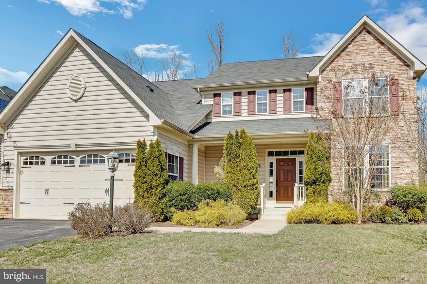Welcome home to this beautiful brick front Colonial in sought after Autumn Hills! Beautifully landscaped front lawn with foundational bushes and arborvitae trees framing the welcoming front porch. Enter into a light and bright 2 story foyer with 9 ft+ ceilings, wide plank Brazilian Cherry floors, and elegant waterfall staircase. You'll have plenty of room to grow in this 4 bedroom, 3.5 bath home with over 4,000 sq ft of space! To the right of the entrance is the formal living room that features plush carpeting, oversized windows and crown molding. Entertain guests easily in the formal dining room that neighbors it, and that features chair railing and a centerpiece chandelier set in a tray ceiling. You'll love the streams of light and private view coming from the large bay windows! The fully equipped kitchen features a custom center island with butcher block countertops and integrated wine fridge. Spanish style tile flooring, waffle ceiling, recessed lighting and subway tile backsplash are just some of the details you'll enjoy. Even more to love in this gourmet kitchen with gleaming quartz countertops, floating butcher block shelves, closet pantry, plus a deep sink with detachable faucet and window view! Also features all stainless steel appliances including a double door fridge with pull out freezer and gas range with custom vent hood. Enjoy everyday meals in the neighboring breakfast nook and morning room that features a vaulted ceiling, wall of windows, and door to access the deck. Relax in the beautiful family room with cozy gas fireplace and gleaming hardwood floors. Half bath plus a laundry room with full size washer and dryer plus rinse sink completes the level. Retreat to the large main bedroom suite that features plush carpeting, cooling ceiling fan, two walk in closets, and an en-suite bathroom with dual sink vanity, soaking tub and glass stall shower with detachable showerhead. Three spacious bedrooms with closets, plush carpeting and hall bath with dual vanity completes the level. The fully finished basement is perfect for additional living space or rec room and includes tile flooring, wainscoting, recessed lighting and wet bar. Full bath completes the level. Enjoy the outdoors in your spacious fully fenced in backyard that features a patio, the perfect place to host a summertime BBQ! Plenty of space to park in the attached 2 car garage and paved driveway. Easy access to 301, shopping and dining. Do not miss out on this one!
