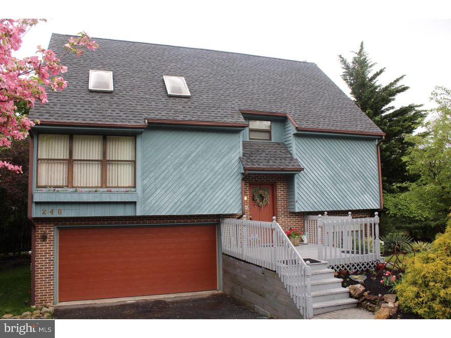 You'll love the manicured, park-like grounds of this lovely property. Enjoy nature on over 1000 square feet of a two-level deck. Step inside and fall in love with the clean, modern colors and lines of this designer showcase. The kitchen has been updated with white cabinets and appliances and there is wonderful family room addition in the back of the house with a built-in entertainment center, lots of windows, and cozy fireplace. The lower level has a huge laundry room, and extra full bath, and a bonus bedroom. The upper level master bedroom has an added, very large walk-in closet off the master bath. Walk-out to the deck from both the lower and the main levels. There is a lot to love on both the interior and exterior of this inviting home.