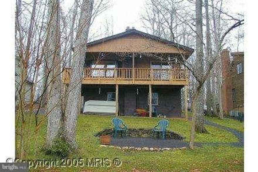 Charming 3 bedroom, 2 bath WATERFRONT Raised Rambler with wrapped porch, circular drive, lots of trees and beautiful lake view. Partially finished basement features separate room with closet and bath.  Enjoy water view and cool breezes during the summer from the porch and toasty view with wood burning stove during the winter.  Priced to sell!