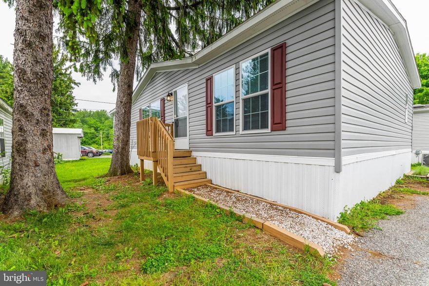 This manufactured home in the heart of Woodstock is ready for immediate move-in!  (The sale is contingent upon Park approval and background check.). You'll love living in a quiet neighborhood, with direct access to Patapsco State Park trails, plus several other trail access sites nearby.  Upon entering, the home, the modern archway will draw your attention leading from the living room to the kitchen and eat-in area.  The kitchen includes light colored cabinets, two-basin sink, a full pantry, awesome island countertop, pendant lights, refrigerator, microwave, stove/oven, dishwasher, and adjoining mud room with both laundry machines. As you go through the home, you'll find a primary en-suite with an attached, updated, full bathroom with a double sink countertop and a roomy walk-in closet!  Two more bedrooms and a second full bathroom give this home amazing  living space.  The mobile home park also includes an open grassy areas for dog walking and is 8 miles from Historic Downtown Ellicott City with tons of shops and restaurants.  Schedule a showing today!