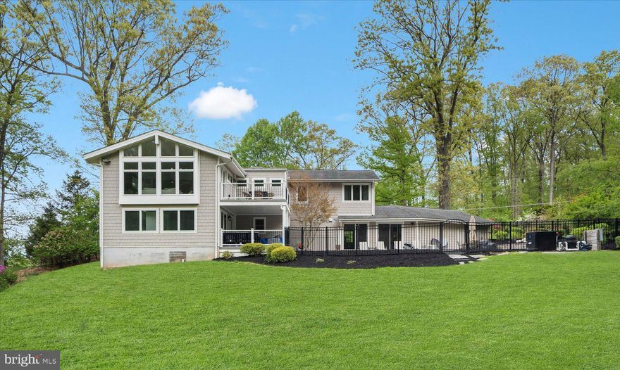 Welcome to your dream home! Upon entry of this stunning split foyer you will be pleasantly surprised by the modern aesthetic and upgrades that will take your breath away. From the porcelain wall with modern fireplace in the living room that flows seamlessly into the open dining room, to the well-appointed kitchen with stainless steel appliances, six-burner stove, & huge bi-level island with seating for 4 and plenty of storage space, you’ll feel right at home. Wedged between the kitchen and great room is a dry bar, providing the perfect hydration station for entertaining. Experience the grandeur of the expansive great room with a soaring ceiling adorned with floor to ceiling windows and a balcony that provides a breathtaking view of the surrounding landscape, just shy of an acre.   Retreat to the huge primary suite with a spa-like ensuite bathroom and a walk-in closet and additional expansive walk closet or relax in the lower level family room warmed by a wood burning fireplace, either way it’s oh so restful here. The luxurious fiberglass, saltwater, heated pool with adjacent bar is perfect for both indoor & outdoor activities. The pool is also a refreshing sight from the great room balcony above. The 2-car garage is prewired for EV charging and the driveway is suited for an additional 6 cars.  This semi-rural sanctuary is 1.5 miles off Main St. Don't miss out on the opportunity to make this stunning home your own!