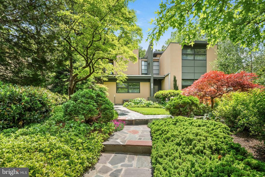 A Jewel in One of Washington’s Most Treasured Enclaves, homes like this are seldom offered in Somerset, with architectural significance, privacy, and thoughtful design. Set back from the street, the residence unfolds through a luminous sequence of layered spaces, opening to sweeping garden views and a direct connection to protected parkland beyond. The architecture balances generous scale with distilled simplicity, following a layout that is both intuitive and intentional. When tasked with expanding the original structure, Mark McInturff, FAIA, one of Washington’s most esteemed residential architects, introduced a sculptural, two-story gallery that serves as both lightwell and corridor. His addition includes elevated bedroom suites, refined material transitions, and a level of detail that earned five architectural awards, securing the home’s place among the region’s finest modern residences. Inside, bridgeways connect private quarters above, while daylight animates every level. The home’s presence is composed and deeply responsive to its site and surroundings. With six bedrooms, five bathrooms, two family rooms, two laundry areas, and a walkout lower level complete with a secondary kitchenette, the layout offers exceptional flexibility, well-suited for guests, extended family, or creative use of space. Located in the Town of Somerset, a coveted enclave within Chevy Chase, this home benefits from a setting rooted in civic pride and community tradition. As an incorporated town, not a homeowner's association, Somerset independently maintains its pool, tennis courts, streets, and community events. McInturff’s architectural imprint is woven throughout the neighborhood, including several private commissions and the design of the community’s own pool house. This is a rare opportunity to own a work of architecture in a place where people choose to stay. Floor plans and video tours are available upon request.