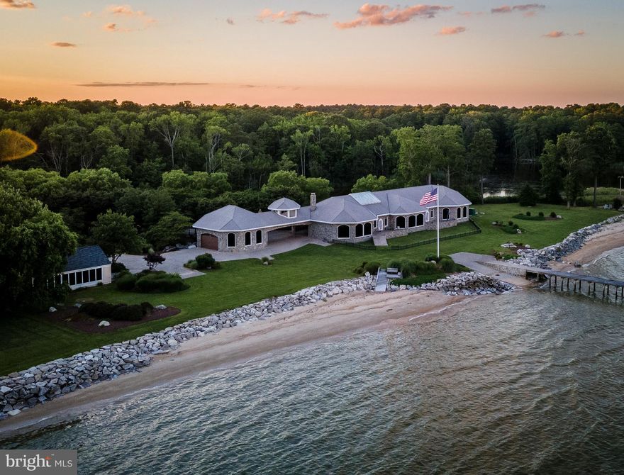 Mediterranean style home with a Caribbean flare!! Property consists of 3 separate parcels.  Main house, full guest house on waterfront lot & 3rd parcel is  pond lot.  Both houses have private beaches & beautiful panoramic views of the Chesapeake Bay.  (Tax info only reflects main house.)    Custom design, custom features, custom materials. No expense spared.   Stone exterior w/ 2x 6 construction. Pella windows and custom picture windows w/ commercial  grade tinted glass.  Slate roof.  Brazilian cherry wood floors thru out w/ marble & tile  in bathrooms. Stone fireplace.  Gourmet Kitchen has high end appliances to include Wolfe gas range  & additional  cooktop.  Two dining areas, one overlooks the pond and the other overlooks the Bay with custom made table and chairs for 20!! High ceilings thru out with custom ceilings & lights.  Indoor atrium w/ waterfall.  Outdoor kitchen has 3 electric roll up doors,  stainless appliances,  granite counter and seating for 10+.  One well , two septic systems. 
560 feet of private beach with plenty of sea glass.  Gorgeous Sunrise views.   Island gazebo.  Pier with sundeck & 2nd gazebo. Sandy bottom makes a great swimming area.   Boat ramp. Rip rap.  Indoor & outdoor sprinklers.  Full house generator.  Brick paver circle drive and parking area.  Portico/ Breezeway to  42 x  36  garage. 2 patios on Bay side.  Multi zone  HVAC system.  Beautifully landscaped, resort setting......
