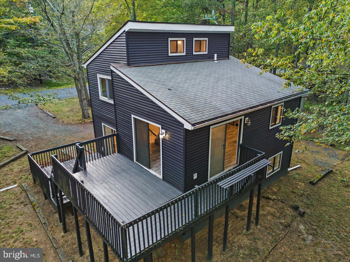 Discover this TRULY UNIQUE 4-Level, 3-Bedroom, 2-Bath Home in the sought-after gated community of A Pocono Country Place. Perfectly designed for both relaxation and entertaining, this home offers space, character, and an unbeatable location. The first level features two spacious bedrooms and a full bath. Upstairs, the second level showcases a bright and open living room with plenty of natural light. The third level includes a welcoming dining area and a fully renovated kitchen with modern upgrades. At the very top, the primary suite offers total privacy with its own full bath and walk-in closets. Enjoy the outdoors on two expansive decks, perfect for gatherings or quiet evenings surrounded by nature. Best of all, the home is just a 300-foot walk to the nearest community beach, making lake life a part of your everyday routine. Community Amenities Include: Multiple lakes for boating, fishing & swimming. Beaches & picnic areas. Indoor & outdoor swimming pools. Clubhouse with events & recreation. Tennis, basketball & sports courts. 24-hour gated security. Whether as a full-time residence, weekend getaway, or investment property, this rare 4-level home offers the best of Pocono living.