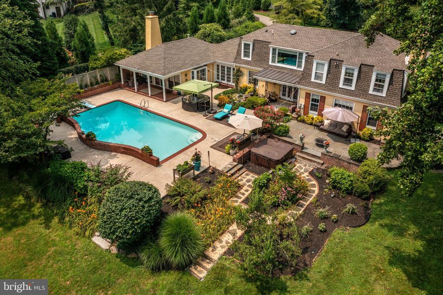 Rarely does a Main Line home become available that combines so many elements to create a magical property, and 745 Woodleave Road is one of them! Located on the North side of Bryn Mawr, within a beautiful neighborhood  and on a quiet cul-de-sac street, you enter the property on a winding drive that sets the stage for the spectacular oasis ahead. Just beyond the side entrance used for everyday life, you'll be greeted by views that that capture your attention by blending the spectacular indoor space with beautiful outdoor scenery. The bright and updated kitchen flows past the French doors, toward an inviting light filled family room, with endless views of the incredible outdoor space. Flower gardens, a water fountain, a heated pool, hot tub, landscaped walkways, and mature trees meld natures visual pleasures with the comforts of resort style living. Through the kitchen and to the dining room, the theme of outdoor views continue with another set of French doors to a cozy covered patio perfect for relaxing or entertaining. A few steps away, again, you'll be taking in the outdoor sights from a large, charming and inviting living room with a perfectly located fireplace. Also on the main level of the home is a bedroom with a full bath, including a private entrance and walkway perfect for a guest suite, nanny quarters, in-law suite or used as a primary bedroom. Up the staircase to the 2nd level, the main bedroom includes another spectacular view of the grounds, a gorgeous renovated bathroom with a glass shower and soaking tub, a large walk-in closet, 2 additional closets and a second bathroom that the owners chose to keep for convenience. This is a great bonus space that could also be combined with an adjacent closet to provide even more closet space, or to create a 2nd floor laundry area. Down the hallway are 2 additional bedrooms, both with sensational views of the property, and a shared hall bath. This home and property has a wonderful and natural flow, great to be shared with family, friends and entertaining or simply alone soaking in the scenery and nature. The owners have made many beautiful updates, which are included in the documents section. Don't miss a chance to view this beautiful property, with a fabulous location!