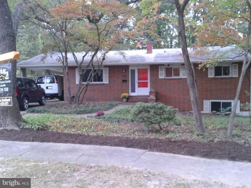 Large, brick rancher on quiet cul de sac.  Backs to woods, gardeners delight. Spacious, newly refinished walk out basement with brick fireplace (suitable for gas log).  Kitchen and 2 and 1/2 baths completely updated.  Unfinished oak hardwood floors under neutral wall-to-wall carpet. Cast iron, hot water baseboard heat with recently replaced boiler.  Chesapeake Schools.