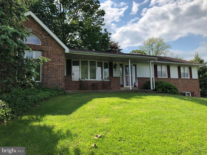 Beautiful brick raised-rancher on a beautifully landscaped rural lot.  Living Room and Great Room. hardwood floors, recessed lighting and cathedral ceiling.  2 story workshop or studio with heat and electric (360 sq ft-public record). Great basement rec room with fireplace and bar (refrigerator in bar area included!). Kitchen refrigerator and a washer & dryer will be included in sale! Lovely, secluded patio/porch area in rear of home opening up to wonderful landscaping to enjoy.