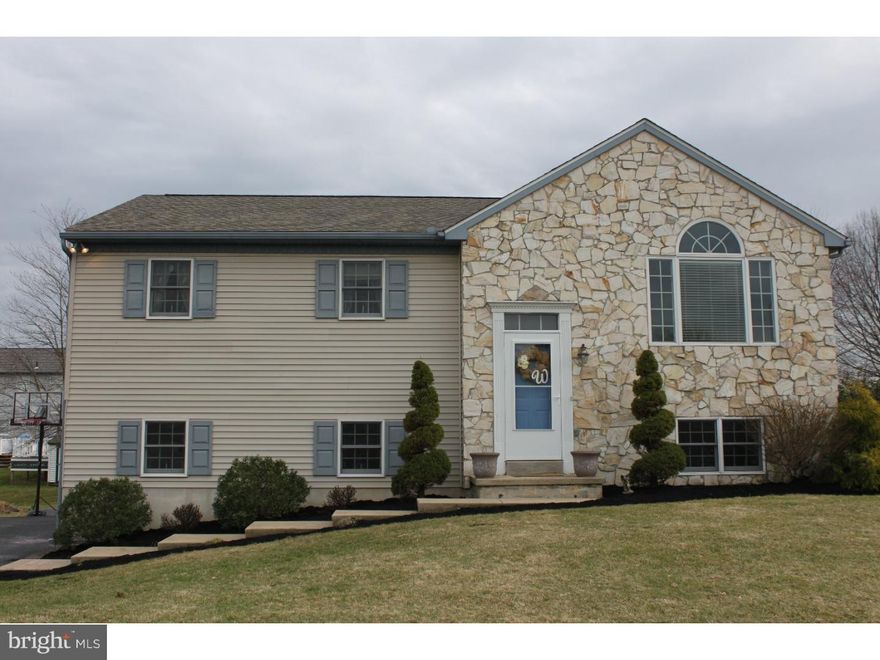 Picture Perfect!  Not your typical bi-level!  Excellent condition.  Features include, but are not limited, to large, very usable yard, cathedral ceilings in kitchen, living room, and dining room, pergo flooring, new carpeting in living room, and bedroom,   breakfast bar in kitchen, large pantry, skylight in bathroom.  Nicely finished lower level with full bath, and sliders leading to patio area.  Oversized Garage with built in shelving, and garage door openers.  There is a newer (2014) roof, updated bath, upgraded lighting, efficient gas heat and hot water and low taxes!  There is a radon remediation system already installed so no worries there!  USDA 100% financing available.   1 yr. home warranty available with an acceptable agreement of sale. Don't miss out on this beauty.