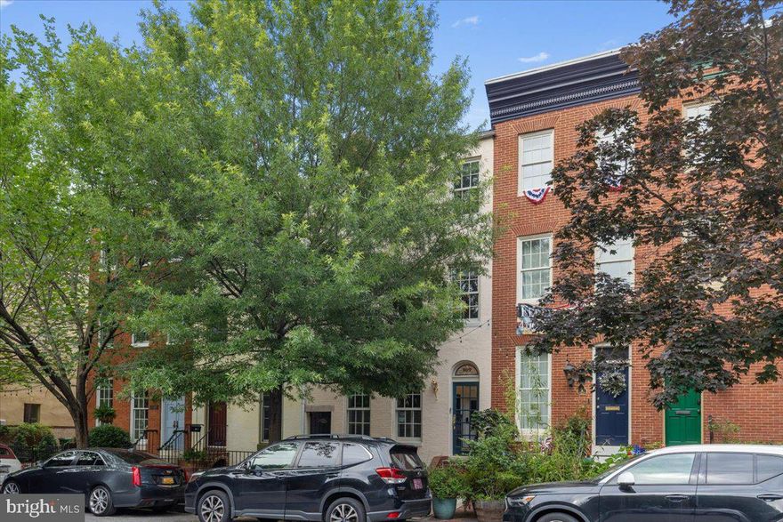 Beautiful three story townhome in the heart of Historic Federal Hill. Gleaming hardwood floors run throughout the home. Enter through the charming vestibule into a welcoming living room featuring a cozy wood-burning fireplace. The spacious kitchen offers abundant natural light and room for a breakfast table, while the separate dining room boasts a bay window overlooking the private backyard, perfect for relaxing or entertaining. A convenient half bath completes the main level. The second floor offers three bedrooms and two full baths thoughtfully arranged for privacy, along with a hallway washer and dryer for added convenience. The third level is dedicated to the expansive primary suite, featuring a walk-in closet, additional double closet, and a luxurious en-suite bath with double vanity and oversized walk-in shower.
 Located on a quiet, tree lined street just one block from Federal Hill Park, enjoy some of the best views of the water and Inner Harbor. Surrounded by an abundance of restaurants, shops, and entertainment, plus easy access to the water taxi for a quick ride to Fells Point and other vibrant waterfront neighborhoods, this home offers the perfect blend of charm, comfort, and city living.  Seller currently holds a membership to the Otterbein Swim Club, which may be transferred to the new owner, if desired.