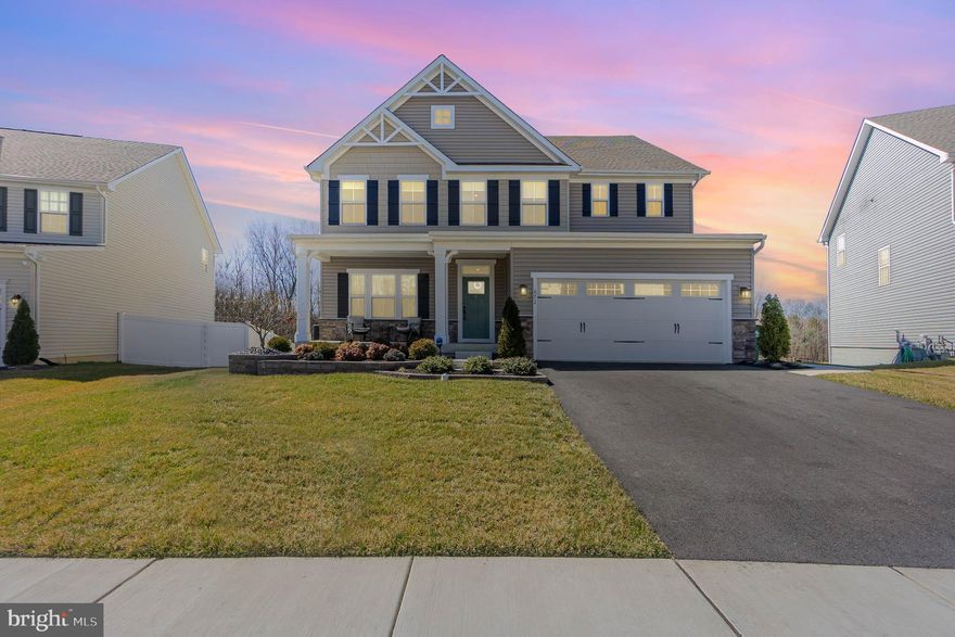 Built in 2021 this home is better then new! Modern Open Floorplan featuring 5 above grade bedrooms & 5 full bathrooms. Enter off the beautiful front porch to a main floor featuring wide plank wood flooring throughout. There is a flex room  to your left which can serve many uses. Walk down the hall to the large kitchen open to the family room & spacious eating area.  A large in-law bedroom & full bath are located away from the kitchen on the  main floor. The kitchen sliding glass door leads to a composite deck backing to trees. Additional main floor features are 9 foot ceilings, 42" kitchen cabinets with quartz countertop, large island with accent cabinets, stainless steel appliances, walk in pantry, wall oven, gas range,  kitchen backsplash, 2 car garage with finished walls & upgraded floor, custom blinds with remote control in family room & kitchen &  garage foyer area perfect for shoe / coat storage. The upper level boasts wood stairs & upgraded railings, wood floors throughout, large loft perfect for entertaining, Primary Bedroom with trey ceiling, ceiling fan, His & Her Walk in closets with professional organizers, Primary Bath with dual sinks & walk In shower, 3 additional spacious bedrooms, 3 additional full baths on the upper level & upper level laundry. Moving to the lower level the entire rec room is finished with plenty of room for an office as well. A full bath (5th full bath) is located in the lower level & a large storage area. The lower level has a walkout basement exit to a custom built paver patio featuring a gas line for a fire bowl and seating wall. There are also stone pavers laid to walk around the home to the front of the house. This home sits on a premium lot backing to trees. Schedule your showing today!!