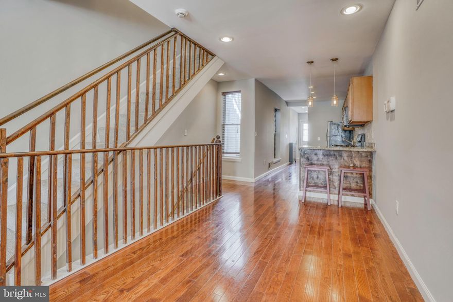 This renovated Federal Hill house checks all the boxes...3 levels with a finished basement. 3 bedrooms, 3.5 baths, hardwood floors, stainless appliances, granite, roof deck, and EASY parking pad. The house is a great set up for roommates but also for a couple that needs home office space. The house has been professionally cleaned and painted from top to bottom.  The main level has well done exposed brick, hard wood floors, a space for dining, a 1/2 bath and laundry too! The kitchen is well done with good counter space (granite) , stainless appl, and a wine fridge! There's a parking pad just off the back of the house with a wide alley way.  Upstairs has 2 bedrooms, each with full baths. The roof deck is large with great city and stadium views! The finished basement has been used as a 3rd bedroom since there is also a full bath down there.  LOCATION: No doubt Federal Hill bars, restaurants, and retail shops are gearing up for a great summer. Walk to them all. Easy access to 95, 83 and downtown! **Home has had a deep clean and freshly painted from top to bottom.