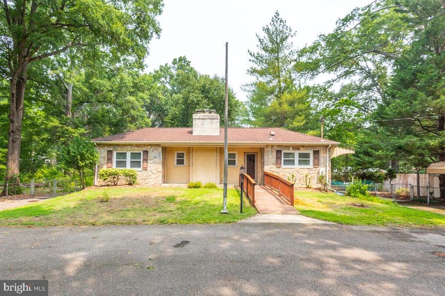 When you arrive the huge circular driveway welcomes you to this Rare find in the Calvert Manor Waterfront Community that has a voluntary community association that gives owners access to the  community dock , boat ramp , pier, playground and pavilion ! - This home has been owned by one family since it was built new in 1952 ! - Main floor has 2 bedrooms - 1.5 baths - living room - brick fireplace and country kitchen. Basement is partially finished with 2nd brick fireplace - 3rd bedroom and 2nd full bathroom. Backyard  is fully fenced and has an oversized 2 car garage.  There are hardwood floors under the carpet on the main floor! This beautiful wooded lot with mature trees is just over an acre (1.06 acres). Great commuting location to D.C. , Northern VA , Joint  Base Anacostia-Bolling and Joint Base Andrews and MGM Grand . To learn more about the voluntary Calvert Manor Community Association you can go to calvertmanormaryland.com