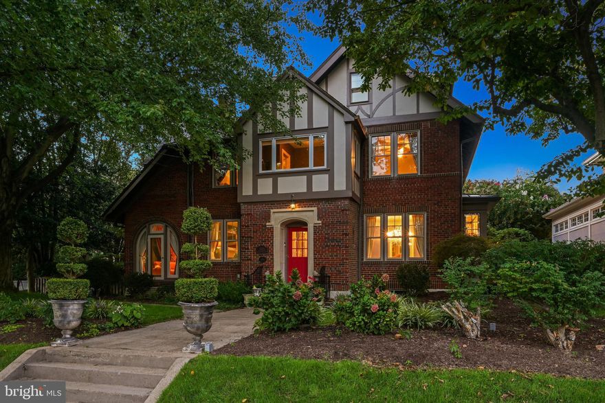 Rarely-available 7-bed, 5.5-bath historic brick front Tudor with detached 4-car garage on one of the most sought-after streets in DC! Ideally-situated in the heart of Chevy Chase, this home provides the best of both worlds with a bucolic setting on a wide tree-lined street, yet just steps to Friendship Heights metro and all of the dining, shopping and nightlife that the city has to offer. Built in 1925, this stately home combines historic charm with modern updates throughout, boasts over 5400 total square feet, and is situated on a large picture-perfect corner lot with professional landscaping and a storybook patio with garden. Enter to the grand foyer and be welcomed with custom wood trim, opulent chandeliers and beautiful hardwood floors throughout. The main level is an entertainer's dream - featuring a formal dining room off the kitchen, a library, a conveniently-located powder room plus a formal living room and adjacent sunroom that share a cozy two-sided gas fireplace adorned with a custom carved wood mantle. The centerpiece of the main level is the gourmet kitchen with timeless white cabinetry, stone countertops, large island, high-end stainless steel appliances including Viking stove and Sub-Zero refrigerator, butler's pantry, and eat-in breakfast area with views of the garden, perfect for enjoying a morning coffee or a good book. When ready to relax, head to the second level owner's bedroom suite featuring hardwood floors, a walk-in closet with separate dressing room and an ensuite bath with tiled shower/tub combo. The attached bonus room with peaceful views of the mature trees is ideally-located to serve as an in-home office, nursery or reading nook. A secondary bedroom suite with ensuite bath is available for long-term guests, in-laws or au pair. Three additional bedrooms and a 3rd full bath complete this 5-bed, 3-bath second level. The finished attic provides a versatile layout with 2 additional bedrooms, full bath and extra storage but can be easily organized into a single large kids' toy room, second office, gym, music or art studio. The fully-finished walk-out basement with recessed lighting boasts plenty of space for a theater room with an adjacent kitchenette for hosting a memorable movie night-in or as a potential apartment rental with full bath, laundry, extra storage and separate exterior entrance. Looking to de-stress after a long day? Step outside the rear of the home and let your mind wander in the serene rear garden. The fully-fenced rear yard is delightfully ornamented with bistro lights, stone patio, koi pond, fire pit, and grilling station. When looking to unwind, head around the corner of the home to the bubbling jacuzzi complete with privacy curtains for a tranquil night under the stars. The massive 4-car detached garage in the rear offers all of the space you'll ever need for multiple vehicles, workshop and additional storage. Plenty of street parking available for guests as well. Recent upgrades include new paint (2023), slate patio (2011), fire pit (2013), water treatment system (2015), jacuzzi (2015), gas logs (2017), and vent hood (2017). Vermont Slate roof inspected Aug 2023 and confirmed to be in great condition (report available). Don't miss this gem of a home!