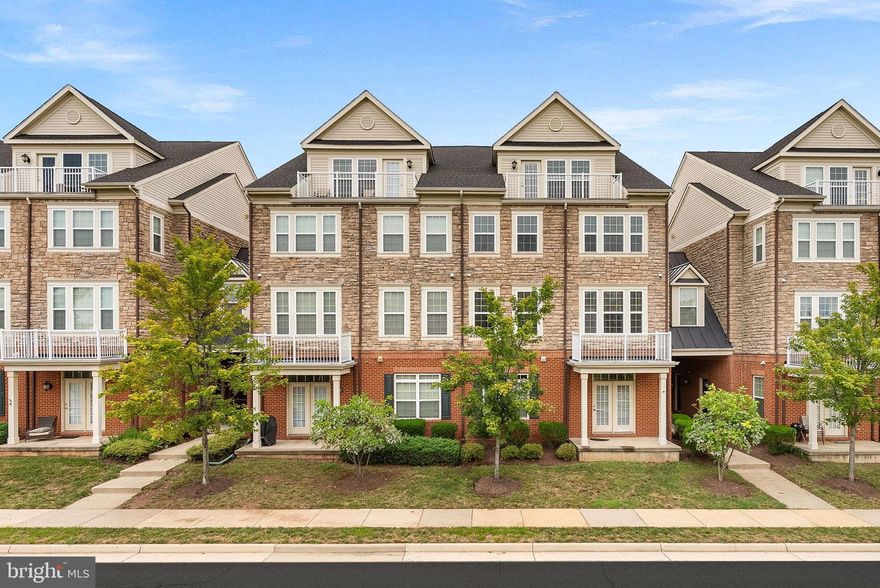 Welcome to this 4-level end unit Lennar Alpine model in the heart of Ashburn, offering 3 bedrooms, 2.5 bathrooms, and a 1-car garage. The main level features a gourmet kitchen with upgraded cabinetry, granite countertops, stainless steel appliances, and a breakfast bar that opens to a formal dining room and a spacious living room with a gas fireplace. Upstairs, the primary suite includes a sitting room, walk-in closet, and a private bath with dual sinks, soaking tub, and separate shower, with the laundry room conveniently nearby. The next level provides two additional large bedrooms and a full bath with dual sinks, while the top level offers a versatile loft with wet bar and rooftop terrace perfect for entertaining or relaxing with skyline views. This home includes garage and driveway parking, ample street parking, plus access to community amenities, all just minutes from shopping, dining, and the Greenway for an easy commute.