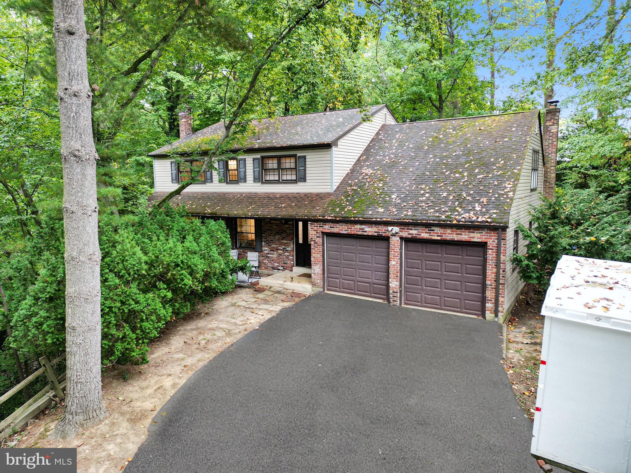 Nestled in a tranquil, wooded setting in Wallingford, this stunning 4-bedroom, 2.5-bath Colonial offers privacy and natural beauty. Set back from the street with a lush, wooded front yard, this home provides a serene retreat, complete with the soothing sounds of a nearby creek. The seasonal views are breathtaking, especially in winter when snow-dusted trees create a picturesque landscape.

Entering the first floor, you'll find a large living room and a formal dining room showcasing beautifully with hardwood floors through out. The home features a custom eat-in kitchen that opens to a cozy family room, highlighted by a gas fireplace and elegant built-in bookshelves. 

The primary bedroom, originally part of a 5-bedroom layout, has been thoughtfully reimagined to include an en suite bath and a spacious walk-in closet.. Two well-sized bedrooms accompany the primary upstairs, and lastly, the fourth bedroom impresses with its vaulted ceilings,  abundant space, and ample closet space. 

The finished basement offers an additional 700 square feet of flexible space for recreation, exercise, a home office, or more, providing endless possibilities for modern living. Additional home features include Pella windows and doors throughout, updated vinyl siding, the replacement of the original asbestos siding, remote keyless AUGUST entry lock

Conveniently located near downtown Media, Philadelphia International Airport, and major highways like Route 476 and Interstate 95, this home offers the perfect balance of secluded living with easy access to surrounding amenities. Home to the Wallingford-Swarthmore School District, this home is close to award-winning schools, including Strath Haven High School, recently recognized as one of "America's Outstanding High Schools" by US News & World Report and Newsweek magazines. Don’t miss out on this must-see property—schedule your private tour today! Seller is offering a one-year America’s Preferred Home Warranty.